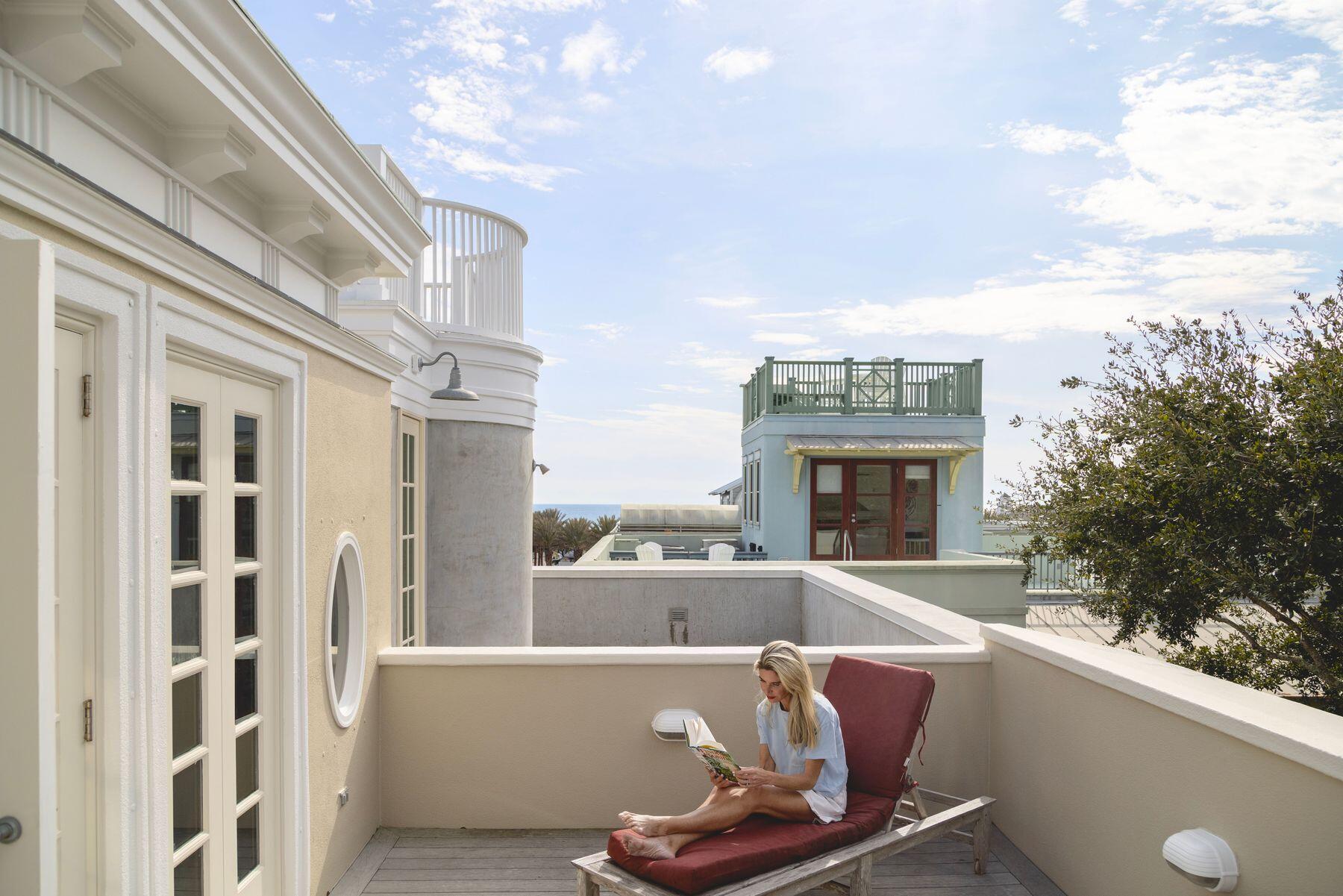 Tucked within the storybook setting of Ruskin Park, where winding pathways lead to charming boutiques and the scent of salt lingers in the air, this stately four-story residence is a testament to timeless coastal sophistication. Designed by acclaimed New York architect Alexander Gorlin, the home is one of the largest in Seaside, Florida — its grand façade blending classic architecture with the effortless charm that defines this iconic beach town.
Just 350 yards from the sugar-white sands and emerald gulf waters, the home welcomes you with a gracious columned porch, setting the tone for the exquisite design that unfolds within. Step inside, where craftsmanship and style intertwine — soaring coffered ceilings, polished wood floors, and arched doorways create a space that feels both refined and inviting.
The first level offers two spacious bedrooms, each a private retreat with its own ensuite bath. French doors open from one suite to reveal serene park views, inviting the outdoors in with a gentle breeze and dappled sunlight. Upstairs, the second-floor living spaces were designed for both elegant entertaining and effortless coastal living. A cozy card game nook beckons for evening gatherings, while a charming breakfast alcove in the beautifully appointed kitchen makes mornings feel like a seaside reverie.
With multiple balconies designed for lingering alfresco moments  coffee in hand as the town awakens or a sunset toast to another perfect day  this home is an invitation to savor the rhythm of Seaside. Offered fully furnished (with select artwork excluded), it's a seamless entry into a lifestyle where boutique shops, renowned dining, the town's iconic chapel and the beach are all just a stroll away.
This is more than a home  it's a sanctuary in the heart of Seaside, where every detail speaks of grace, comfort and the enduring beauty of coastal living.