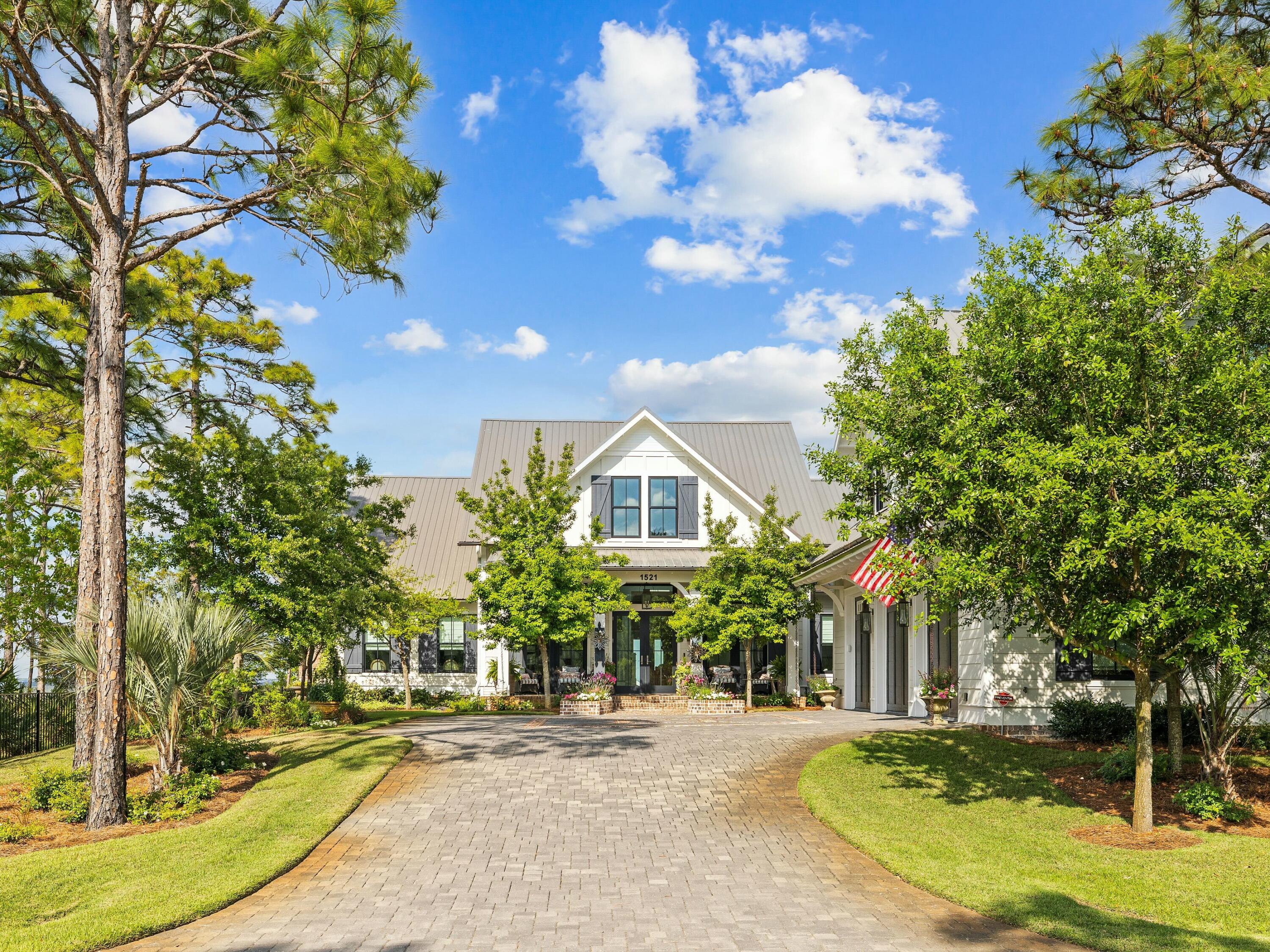 Positioned along the tranquil shores of Choctawhatchee Bay, this extraordinary home in Driftwood Estates offers an unparalleled waterfront lifestyle. Built in 2019, the 5,822-square-foot residence is a showcase of Low Country elegance, combining refined architectural details with modern comforts. Designed for both relaxation and entertaining, the home features four bedrooms in the main house, with additional guest quarters above the detached three-car garage.  The first floor offers a thoughtfully designed layout, including a master suite with a private heated ''spool,'' a chef's kitchen with a butler's pantry, a spacious office and an open-concept living and dining area. A stunning bayfront sunroom invites endless views of the water, seamlessly connecting indoor and outdoor living. The expansive outdoor amenities include a multi-tiered dock with multiple decks, a fire pit, a heated bayfront pool, a grilling station and a covered dining and entertaining area with retractable screens.  

On the second floor, two ensuite guest bedrooms open to a private balcony overlooking the bay. An additional living area, a heated and cooled storage room, and a hidden "Speakeasy" room provide even more space for entertainment and relaxation. No detail has been overlooked, from the built-in Miele coffee bistro and Wolf gas range to the whole-home generator, water filtration system and smart automation for security and appliances. Built-in Sonos speakers, ventless gas fireplaces and dual-zone wine storage for 170 bottles further enhance the home's luxurious appeal.  

The private dock is equipped with a 12,000-lb. lift, accommodating boats up to 28 feet, making this property ideal for those who want to enjoy the bay to the fullest. Every bedroom and living space is designed to capture breathtaking water views, ensuring that the beauty of the bay is never out of sight. Offering exquisite craftsmanship and an exceptional outdoor lifestyle, this home is an opportunity to experience waterfront living at its absolute best.