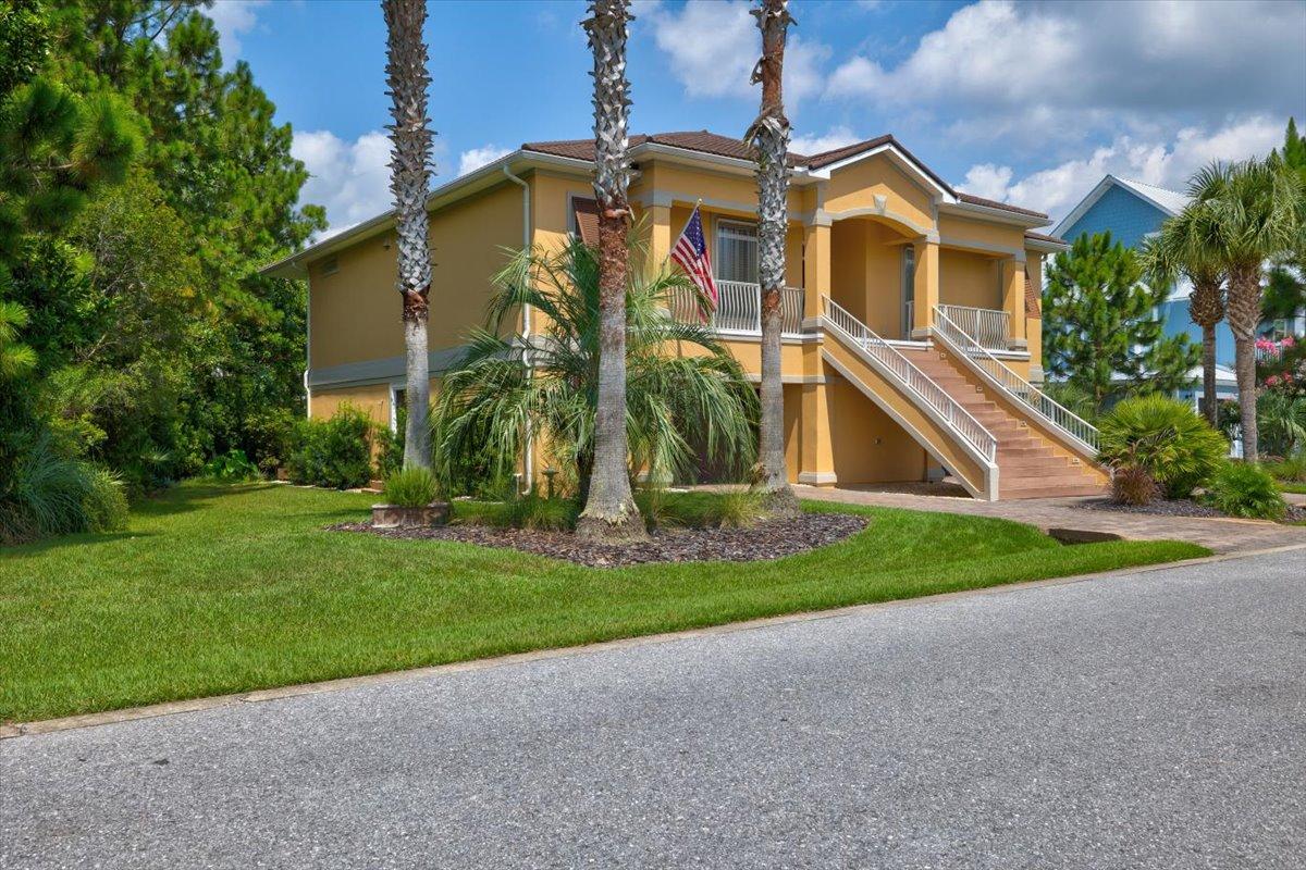 This custom two story home is located in Cypress Breeze Plantation approximately 1/2 mile from the Gulf of Mexico. Kick back and enjoy the lifestyle the Beaches of South Walton has to offer. Bike ride to nearby Ed Walline public beach access, Gulf Place, restaurants and shoppes of 30A or enjoy the magnificent community pool with waterfalls and plentiful deck area. A conservation area surrounds two sides of the home for privacy. Climb the Trex decking staircase with courtesy lights or drive into one of two garages via a paver driveway to take an elevator to the second story of the home. The main living area located on the second floor has Hardwood Brazilian Cherry floors, Spanish Lace ceilings bullnose corners, crown molding, 10' ceilings, 6'' baseboards, and a central vacuum (featuring central dust pans). To the left of the foyer is the formal dining room with a tray ceiling and chandelier dimmer. The dining room leads to a ''perfect for entertaining'' kitchen featuring colorful pendant lights over a 14 foot granite breakfast bar with seating for 6, two dishwashers, refrigerator with bottom freezer, several glass front Cherry cabinets, two Thermador (convection/traditional) ovens and a gas six burner stove with griddle and pasta water spigot, ''artsy'' tile back splash, Jenn-Aire flue exhaust, hot water dispenser, central island and gathering table-height granite bar area with multiple built in wine coolers, wine rack, automatic lighted generous food pantry, bar sink, and ice maker. The kitchen leads to a convenient home office with bamboo flooring facing the front of the home. A dining area overlooks the Travertine tiled back patio with three sets of tinted patio doors extending the entire length of home, and dimmer lights over the dining table area. Features of the living room include can lighting, floating shelves flanking the gas/vent-less fireplace, wired for surround sound with openings for electronics. A half bath is located on the second floor with an indigo blue bowl sink and faucets mounted on the white natural wall tiles. The master bedroom features access to the patio and two large walk-in closets, jetted tub, beveled glass mirrored double vanity, custom cabinets, porcelain ceramic tile flooring, rain spout walk-in shower, and four body shower nozzles. A full-size laundry room with Kenmore Elite washer and dryer, laundry sink, and pretty chandelier is accessed from the master bath. Before heading downstairs, you will find a full coat closet with access to the attic upstairs and a linen closet under the stairs. A family room overlooking a patio (a private backyard beyond) is located at the foot of the stairs featuring can lighting, accent lighting, and a sink. The main level patio has a gas hook-up for a grill and plenty of seating area. The bedroom to the left of the family room has a private bath with a deep garden tub, ceramic tile, and beveled mirror. The guest bedroom has a pocket door leading to a full guest bath as well as access to the outdoor patio. Two large garages on main level contain an area with sink, a separate storage room, garage cabinets, security side entrance and motion sensor light. Iron remover system on sprinklers keep Zoysia grass velvety soft. Other features include hurricane shutters on every window, water filtration system, and a convenient outdoor shower when coming back from the beach. A Girard steel roof (looks like tile) provides protection and is aesthetically pleasing. HVAV system was replaced in 2019. Golf cart does not convey. Home is being sold unfurnished with option to purchase select furnishings, golf cart, bicycles and other equipment at additional cost. Call today for your private showing at this beautiful home.