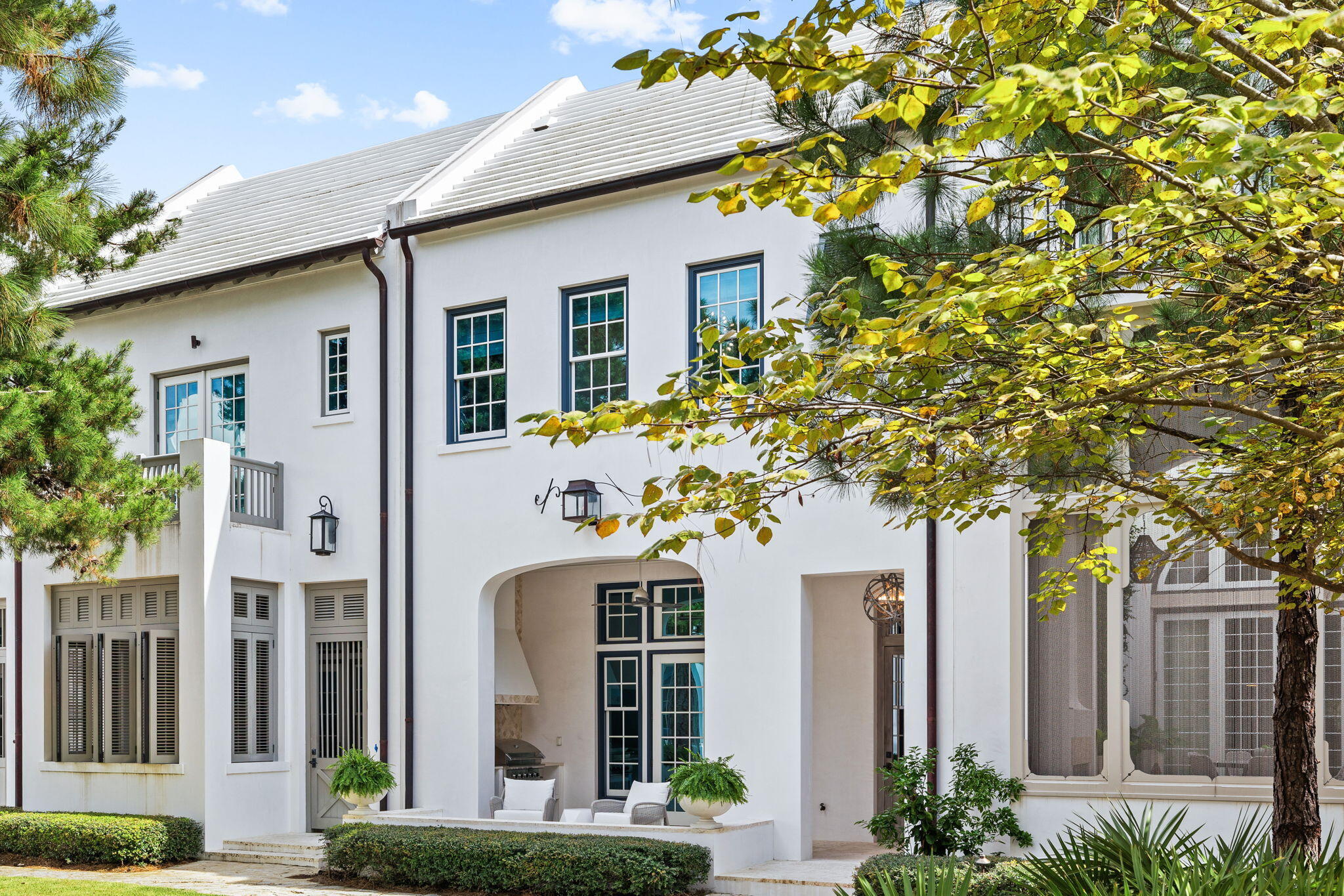 This beautifully designed courtyard home by Gary Justiss is brimming with architectural character and charm. Extra-high ceilings, a second-floor flex space and a coveted primary suite with a sitting nook raise the bar in this masterfully curated space. Perfectly positioned overlooking verdant Arboleda Park, the harmonious lifestyle is enhanced by the ever-present sound of cascading water. This stylish home is a lesson in luxury with Venetian plaster walls, beamed ceilings and tasteful decor creating a calming ambiance. The pristine white kitchen has a wall of French doors providing ample natural daylight and easy access onto the paved patio. A range of glass-fronted display cabinets, designer tile backsplash, Thermador appliances and subtle under-cabinet lighting complement the island bar and prep space. The gourmet kitchen flows naturally into a dining area for entertaining, complete with a tongue-and-groove feature wall. Open doors put you within sight and sound of the courtyard water feature, transporting you effortlessly to an Italian-style oasis. These calming sights and sounds are best enjoyed from the shady private loggia where a fitted summer kitchen with chimney extractor provides an alternative for alfresco dining. Stairs lead up to an open office area, two enviable guest suites and a built-in bunk room for young guests. This attractively priced property makes a great entry point to Alys Beach, being one of the least expensive homes currently on the market. It includes a two-car garage, Control4 automation and privileged access to Alys Beach Club, Caliza Pool and Zuma Health and Wellness Center, among other owners-only perks. Much more than just a home, this luxury abode opens the door to an indulgent lifestyle that includes tennis, high-end dining, green parks and white sandy beaches at the doorstep.