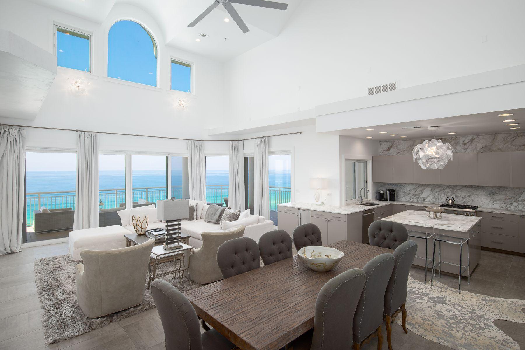 An aspirational gulf-front lifestyle awaits in this modern 6-bedroom penthouse condo in Hidden Dunes, a luxurious gated resort in Miramar Beach, Florida. This two-story beachfront property boasts double-height ceilings in the living room and awesome gulf views. High-end furnishings and a tasteful modern finish are present throughout this completely remodeled bespoke condo. The design goes beyond the norm with grey-and-white marbled walls and counter-tops in the gourmet kitchen and throughout the master bath. The living space is complemented by walls of glass doors that lead to a wrap-around balcony space for maximizing the breathtaking panoramic views of the sparkling emerald gulf, particularly at sunset.
Hidden Dunes is a spectacular gated beachfront resort on 27 acres with walking paths winding through natural vegetation connecting cascading fountains, four pools, and fun sports courts include pickle ball courts, horseshoe pits and a lighted basketball court for playing in the cooler evening air. Owners enjoy swimming and relaxing in the amazing gulf-front pool and spa on expansive decks complete with entertainment bar and ice maker. A convenient walkway leads directly to the private deeded beach with chair and umbrella service. This rental-restricted community includes private security, a state-of-the-art fitness center, covered parking garages, and a grand community room for social events.