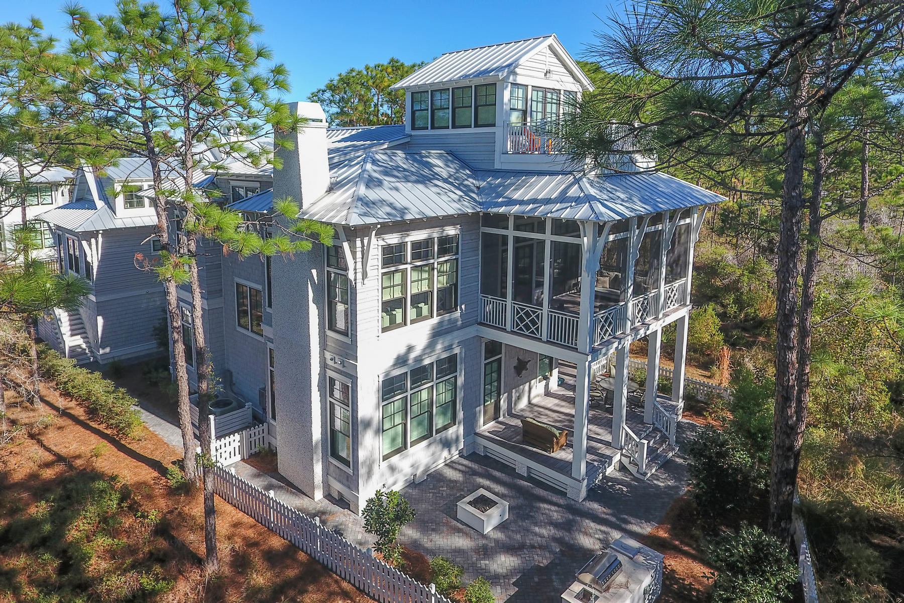 Luxurious lakefront 6 bedroom, 6 bath custom home is located in Vermilion Point, WaterColor's most coveted neighborhood. Bathed in an abundance of natural light with high end details throughout, this architecturally significant residence was designed by Dawn Thurber and constructed by Borges Brooks Builders and captures the spectacular views of Western Lake leading to the Gulf of Mexico. Boasting the highest construction standards and upgrades, the open interior floor plan features dramatic high ceilings, moldings, custom tile and lighting, reclaimed oak floors and beams, and ship-lap wall boarding. The chic gourmet kitchen with marble counters, large island, professional appliances, built in pantry and sun drenched breakfast nook spills in to the spacious family room. Two master suites, separate flex space for kids, media room, large screened porches, several decks and carriage house with two sleeping quarters are just a few of the must sees that elevate this property to a new level of luxury. Outside, enjoy the beautiful outdoor spaces with fenced in yard, built in BBQ, and fire pit all surrounded by mature landscaping and just steps from the lake. With room for a pool, this home has it all.