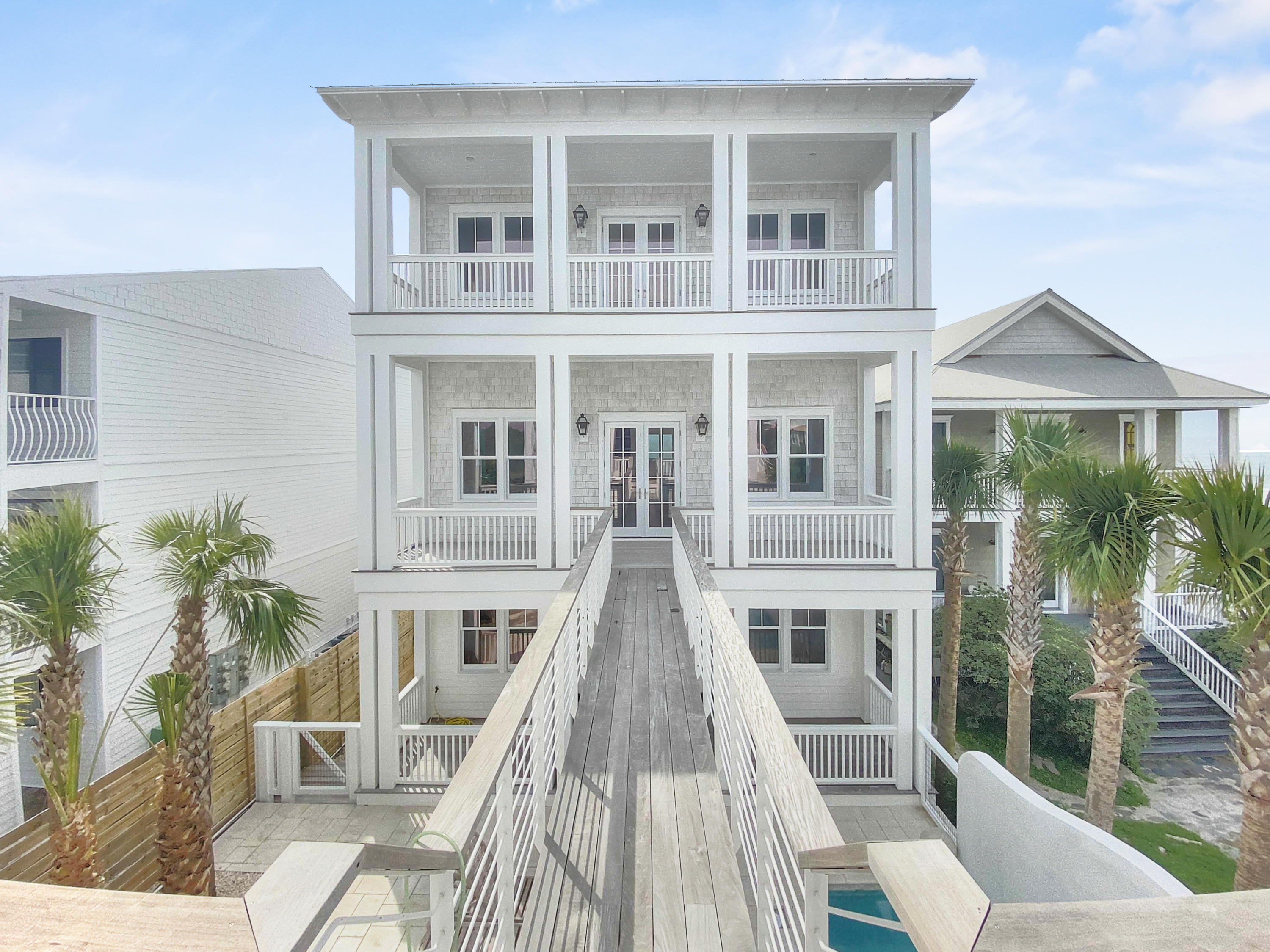 Create a legacy unlike any other where your family can enjoy an unparalleled lifestyle for years to come. Envision an estate where many generations can cherish daily panoramic sunsets & sunsets, beach days filled with sunshine just steps from your front door and a place to relish in the simple pleasures of life. This stunning 30A Gulf-front three-level residence, with a gorgeous main house, guest house, and 2-car garage is the perfect tribute to your family. The property boasts morning sunrises and evening sunsets off the expansive porches affording outdoor living as it was meant to be and is wonderfully suited for entertaining guests or relaxing in the heated pool in the courtyard surrounded by stunning privacy landscaping. The Main House demands immediate attention from the circular sewn reclaimed Heart Pine hardwood flooring to the hand-hewn beams adorning the vaulted ceilings. The entry gives way to a spacious laundry and leads to the gourmet kitchen featuring prestigious marble countertops atop the custom cabinetry inset with beaded-face frames and a suite of Wolf & Sub-Zero appliances. The eye is drawn to the inspiring views from the Gulf facing Great Room. Warmed by an abundance of light from the accordion doors and a Venetian clad fireplace. An elevator provides access to all three levels of the residence. On the second level dueling master suites will vie for your attention, each its own sprawling outdoor haven overlooking the sparkling Emerald Coast. The perfect place to pamper yourself, the stately bathrooms features a luxurious marble spa-tub, an oversized shower, sitting areas and large walk-in closet. The guest suite offers a peaceful retreat after a long day on the beach. An additional laundry on the 2nd floor is provided for convenience to the upper levels.

The 2-story Guest Cottage is connect to the main home by a private walkway and is a peaceful space, that provides privacy and while still being able to feel and smell the Gulf breezes. The cottage has its own unique and lavish qualities, 2 guest suites, great room, and kitchen, making this property truly one of a kind. The upper floor offers another living area, adjacent to two additional suites with amazing Gulf views and private porch to enjoy the crash of the waves with your morning coffee or evening glass of wine. The spacious spa-like bath boasts marble throughout, double vanities, walk-in shower and large soaker tubs, and flanked by walk-in closets.

As an investors dream, rental projections are over $625,000 gross annual rental income. This residence is offered fully outfitted with designer furnishings. While this extravagant oasis is convenient to all that 30A has to offer, it preserves the ambiance of a secluded paradise creating a serene and carefree life.