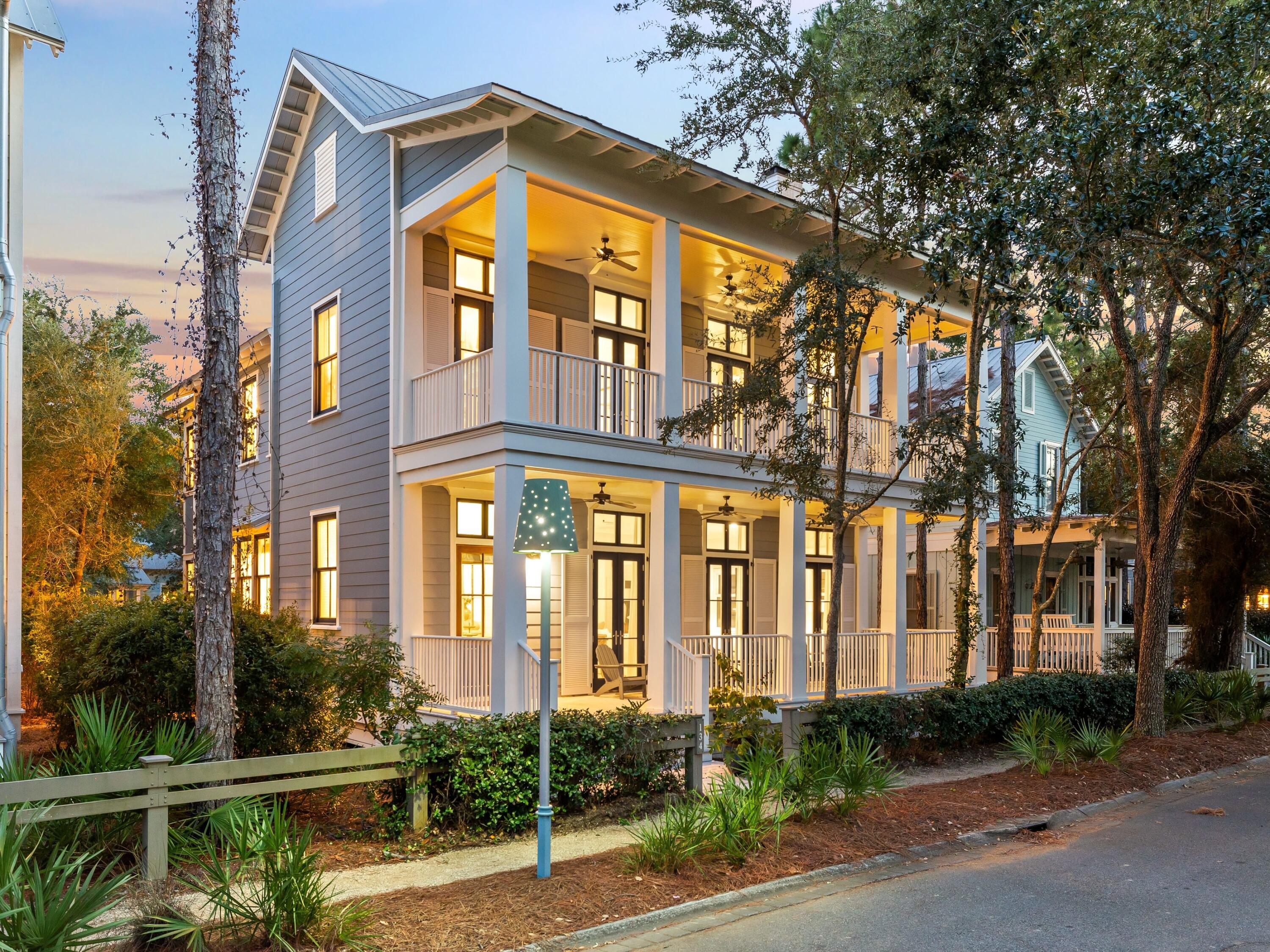 Just beside Camp WaterColor and positioned in one of the community's most sought-after locations, 134 Spartina Circle is a porch-friendly coastal retreat that blends timeless architecture with meaningful, high-end upgrades. Offering over 3,500 square feet of interior living plus 630 square feet of deep, stacked front porches, the home creates an inviting sense of arrival and an effortless flow for relaxed WaterColor living. Inside, the residence feels warm and elevated, anchored by heart of pine floors, high ceilings, and beautiful custom millwork throughout. The oversized living room is designed for gathering, featuring a cozy fireplace and ample space for lounging or a game table, while the kitchen connects seamlessly with updated finishes and premium appliances, including a Sub-Zero refrigerator, a gas range, and an expanded island that makes hosting feel easy and natural.

The layout is both functional and generous, with a first-floor guest suite and full bath ideal for visitors or multi-generational comfort. Upstairs, the primary suite is a true retreat with a spacious bedroom, an oversized walk-in closet, and a beautifully renovated bath featuring a soaking tub and refined finishes. Additional guest accommodations include two king suites with ensuite baths, along with a charming bunk room, creating flexibility for full-time living, second-home enjoyment, or strong rental appeal.

Outdoor living is just as inviting, with a private patio designed for memorable evenings, complete with comfortable seating, a brick fireplace, and a propane grill for effortless entertaining. Throughout the home, thoughtful enhancements like refreshed lighting, custom window treatments, and refinished flooring add a clean, polished feel while preserving the classic WaterColor charm.

With access to WaterColor's celebrated amenities including Camp WaterColor, the Beach Club, and the BoatHouse on Western Lake, this is a rare opportunity to own a fully furnished, move-in-ready home that delivers both lifestyle and long-term value in one of 30A's most iconic communities.