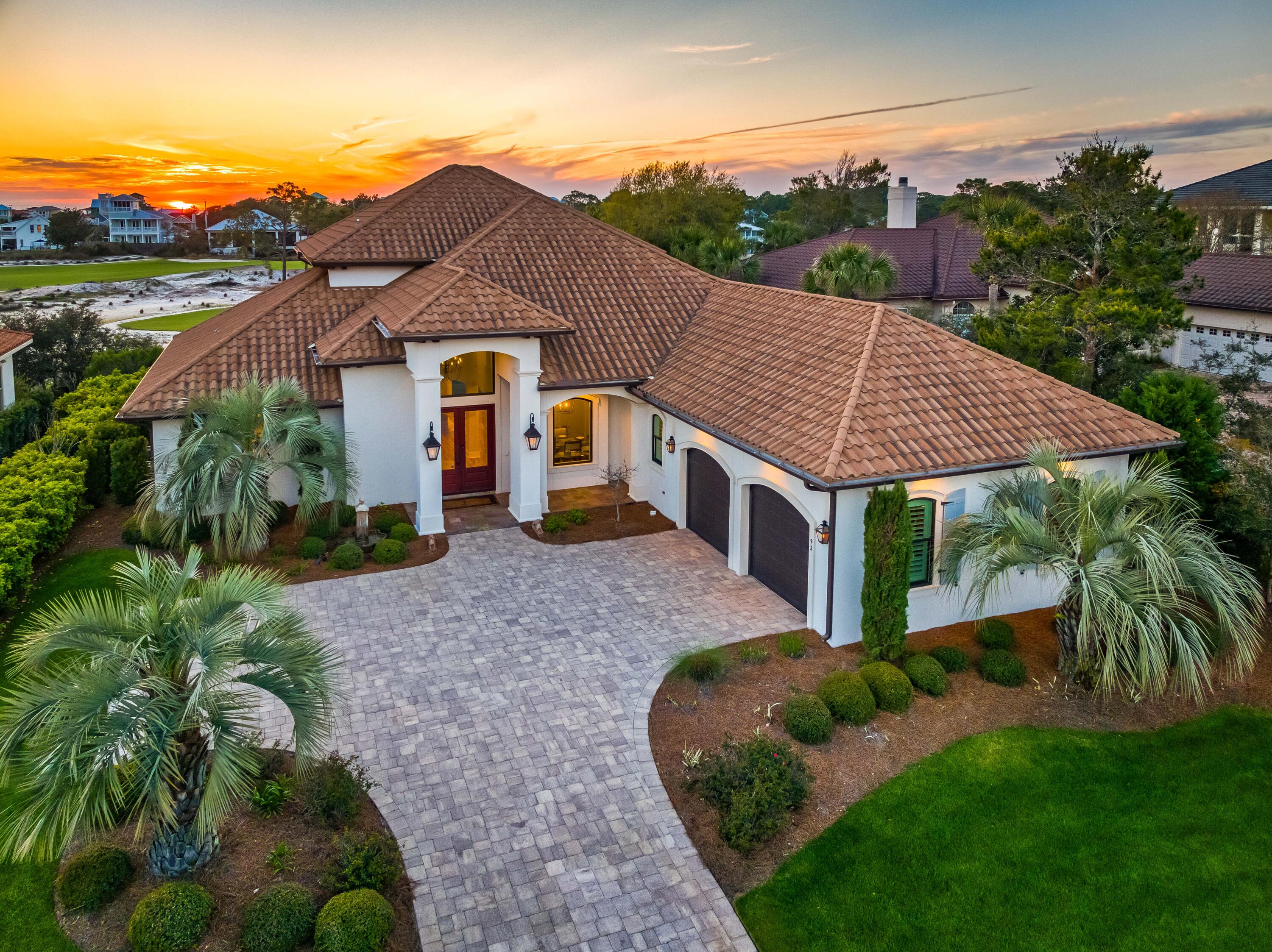 Welcome to the stunning 93 Emerald Ridge located on the Santa Rosa Beach Golf Course in the prestigious gated community of Bellamar at Gulf Place. This home offers a luxurious lifestyle with an array of superior features.
The home spans a generous 3,744 square feet heated and cooled, and a total of 5,241 square feet including the homes many outdoor spaces and 2 car garage. From the spacious 2nd floor balcony, you can enjoy gorgeous western facing Gulf views overlooking the 5th fairway! With 4 large bedrooms and 4 full bathrooms, this house provides ample room for comfort and relaxation. The open floor plan glows with natural light, enhancing the overall ambiance of sophistication and elegance. The interior design perfectly balances modern aesthetics with timeless elegance. The master suite is conveniently located on the main level, offering ease-of-access without compromising privacy or luxury. From here, you can enjoy western facing views overlooking the golf course and the home's private pool. The home's spacious open floor plan includes a dedicated dining space, living room with built-in cabinetry and open shelving, and a large kitchen with breakfast bar that offers the perfect place for family and guests to gather. The telescoping sliding glass doors open to the screened-in pool area that creates seamless indoor/outdoor living. There is a guest bedroom on this level, a dedicated wine room, plus a spacious laundry room with utility sink, folding area, and TV. The oversized 2 car garage provides great space for 2 vehicles plus all of your beach gear, and provides access to the walk-in attic space, great for convenient additional storage. 
Outside, there's more to love: a large private pool invites you to unwind under the Florida sun while enjoying the serene atmosphere of your surroundings. Moreover, being situated on a golf course lot means you'll have privileged access to top-tier golfing facilities right in your backyard.
Beyond the confines of this spectacular home lies a rental-restricted neighborhood designed for full and part time residents who appreciate an active coastal lifestyle amid tranquil settings. As part of Bellamar at Gulf Place community, residents have easy access to the beautiful Gulf beaches via the neighborhood deeded beach access, as well as access to the community's many walking trails. 
Santa Rosa Beach offers its residents more than just beautiful homes; it provides a vibrant lifestyle filled with outdoor activities such as fishing, paddle boarding, hiking and biking. The area is also known for its award-winning dining establishments where one can savor fresh seafood dishes and other local cuisine. You'll enjoy walkability to world class dining at The Vue, situated Gulf front just across 30A from Bellamar. The noteworthy Shunk Gulley restaurant and many unique boutiques and retail shops are also available nearby at Gulf Place. 
This luxurious home at 93 Emerald Ridge, is not just a property, but an invitation to experience the best of Santa Rosa Beach lifestyle. With its prime location, superb community features and unmatched views, this residence is truly a gem in the heart of Florida's Emerald Coast.