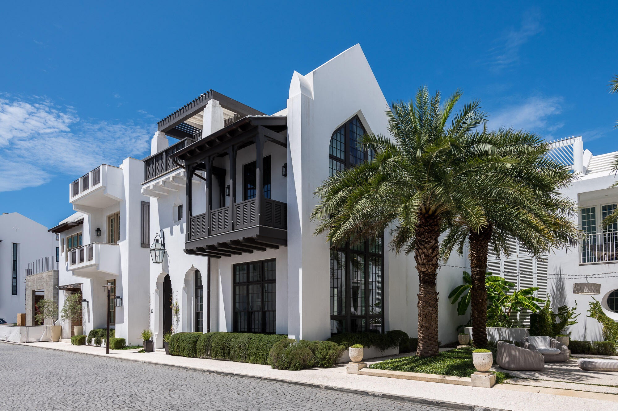 Domin Bock Architects fully captured the Alys Beach lifestyle interacting the beauty & solitude of the famed Palmera Park to this magnificent home. Located South of 30A, the serenity of the park setting further enhances the homes design and elegance. 
This stunning property is within steps of the Gulf Green beach access. Livability is not questioned with this property. 86 S Charles Street allows for full-time residency with the generous living aspects the home offers boasting 3,424 square feet of conditioned living area and abundance of outdoor living. Chelsea Robinson Interiors created comfortable, timeless furnishings and appointments that are 2nd to none.
This 4 bedroom, 4 ½ bath home consists of a stunning master suite that sits beneath a beamed, vaulted ceiling featuring the bishops hat floor to ceiling window looking upon Palmera Park.  The suite boasts a large walk-in closet with custom built-ins and dressing vanity. The en suite bathroom's focal point is the soaking tub with an opaque shell surround which is situated between separated spousal vanities.  A large shower room and mechanical TOTO water closet complete the space.  Lastly, the master suite opens to a couple's balcony overlooking the Gulf of Mexico to share coffee or cocktails.  
Each of the three guest suites provide en suite bathrooms and each is individually decorated creating its own personality.  All guest suites open to lavish outdoor spaces by way of French doors to leave open when weather permits. The 3rd guest suite is detached that opens to a vaulted loggia with seating to gather outfitted with a personal beverage center. This suite is accessed by way of the main home or an exterior stair for private access.
The outdoor living for the home is unparalleled from top to bottom. The 1st floor courtyard has plentiful outdoor seating for entertaining and dining. The summer kitchen is nicely appointed and prepared to entertain.  Transitioning to the 2nd is surrounded by a covered terrace & loggia which allows you to ascend to the homes 3rd story roof terrace hosting Gulf views & a nice area to gather in the evenings.  
For culinary needs, the magnificent professional kitchen is appointed with a large island strategically aligned with courtyard views. This gourmet kitchen boasts a 48" Wolf Range, Sub-Zero refrigeration, pellet icemaker, and full height wine cooler. The dining and living are congruent with the kitchen for entertaining. The Butler's pantry provides a Wolf Steam oven and Wolf microwave, refrigerator drawers and plentiful custom cabinetry.  
The living room is decorated beautifully with custom furnishings surrounded by floor to ceiling windows allowing gorgeous natural light to flow at all times of the day.  The custom shear window treatments create silhouettes casting shadows onto the Cocina Shellstone flooring.  The 12' ceilings add nice volume to this lavish space.  
This is incredible home is a very short walk to the private owners Beach Club and steps to the Gulf Green beach access.