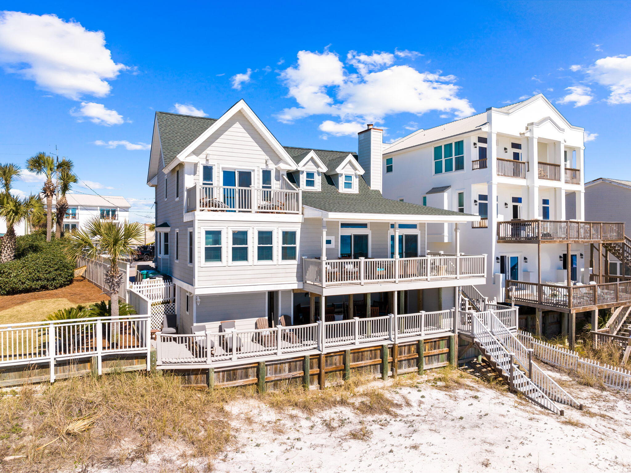 Located on a larger lot just east of Frangista Beach, this updated gulf-front home has plenty of parking and outdoor living space and no HOA. Fifty-two feet of prime beachfront provides uninterrupted views of the shimmering Gulf of Mexico and direct access to the stunning white sand. You'll start to unwind the moment you step inside this light and spacious beach house, which benefits from an open floor plan. The spacious family room has plenty of room for socializing, relaxing and dining. However, you'll probably spend most of your time enjoying gulf breezes as you relax on multiple well-planned decks. The capacious kitchen has quartz counters and everything you need to serve up snacks, drinks and family meals. Start the day together around the breakfast table within sight and sound of the waves. Walls of glass and wraparound balconies provide an abundance of light and a surreal sense of being out on the water. Three floors of living space boast new flooring. Recent exterior renovations include a new roof in 2022, updated electric wiring inside and out, new hardy-plank siding, new decking and new water heater. Additional interior updates include a complete kitchen renovation, fresh paint inside and out, new flooring throughout and two new bathroom showers and vanities. The home currently sleeps up to 17 guests and is a top performing rental. The top-floor master suite boasts a luxurious bathroom with twin vanities and backlit mirrors. Wake up to dawn breaking over the gulf as you enjoy morning coffee on your own private balcony. There's another guest bedroom and bathroom on this upper level. A second master bedroom, a built-in bunk room and two bathrooms are located on the main level, while the lower level has a huge covered patio with seating, an outdoor shower and direct access to the beach. This well-located retreat includes ample paved parking for five cars behind a white picket fence. Located on historic Scenic Gulf Drive in Miramar Beach, it's a short walk or golf cart drive away from great restaurants and shops.