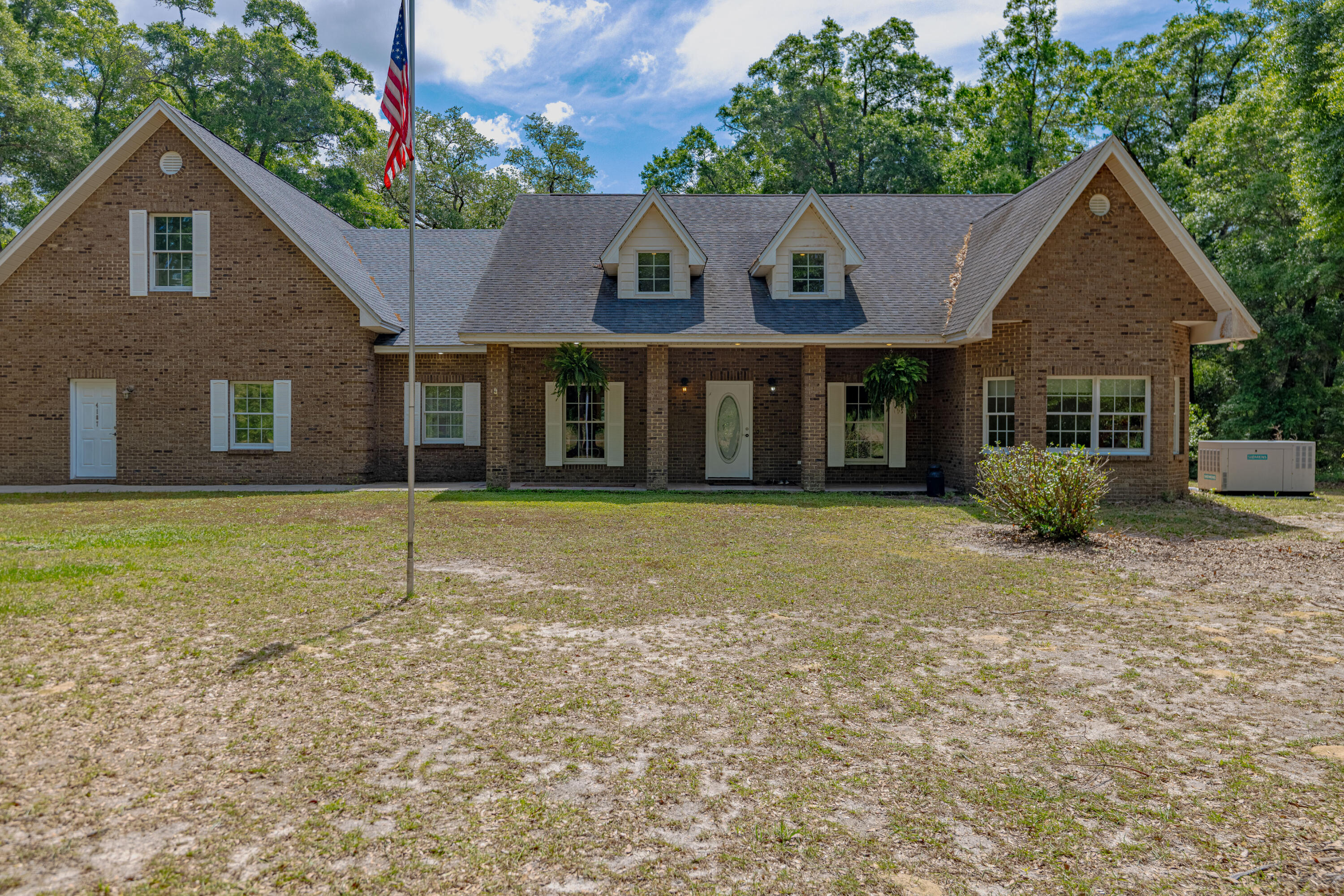 :Additional acreage available! Nestled between Holmes Creek and the Choctawhatchee River, this brick home combines the serenity of country living with all the luxuries of modern amenities. You can launch your boat at the nearby public boat launch for great fishing or swimming in the nearby springs. 4 spacious bedrooms and 3.5 bathrooms, this home is designed for comfort and convenience. The large kitchen features a double oven and an oversized refrigerator.  The open-concept layout allows the stone fireplace to become the focal point of the main living area. The master suite and two bedrooms are conveniently located on the main floor. Upstairs is finished above garage.  Step outside on screened porch - complete with sink and fans. Full Generator for assurance of never losing pow