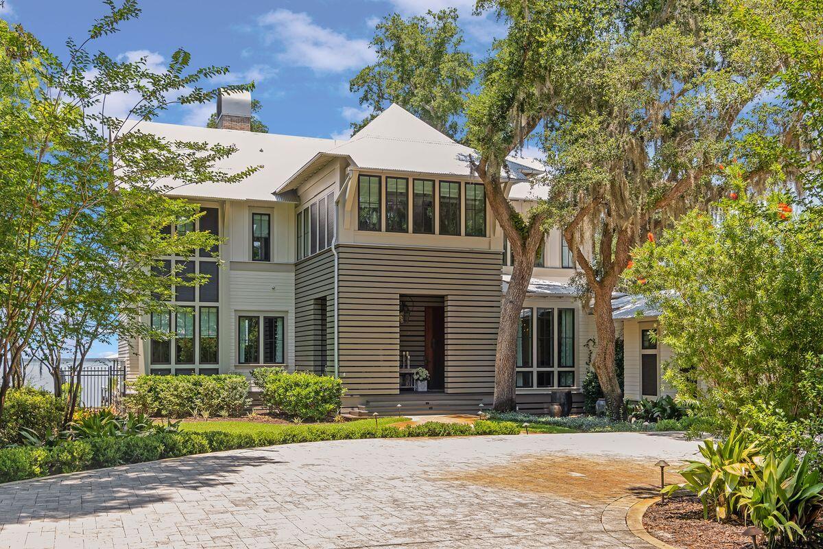 Prominently located on 100 feet of bay front in Point Washington with private dock, bayside pool, summer kitchen and screen porch, this stately home is nestled on almost half an acre with indoor and outdoor living providing captivating views from every room. Located 10 minutes from 30A and the excitement of Seaside, WaterColor and Grayton Beach, it is no surprise John Galvas Construction selected this location to build his personal residence with exceptional quality products and thoughtful design. The shaded tree-lined drive welcomes you into this captivating sanctuary. An open living area with oak beams and floor to ceiling retractable doors flows to the gourmet kitchen with 14 ft island.  As an added bonus, the spacious prep kitchen provides custom cabinetry, drawers, and counter space to optimize organization. A formal dining room overlooking the lush front yard makes entertaining a breeze. The main floor also contains two office/hobby areas and an incredible separate bar with cozy seating and glass shelves overlooking the bay. The entertaining continues onto the pool deck for sunset drinks and evening gatherings around the bay front fire pit beneath the star-strewn sky. The indoor glass elevator whisks you to the  second floor where the allure continues in the impressive primary suite. The marble master bath provides a spa-like experience overlooking the bay while the large closet with custom storage provides a place for everything . This level also contains 3 guest suites, all with en suite baths. The 2nd floor porch runs the entire length of the home for a constant feel of bay front living. This custom smart home boasts the latest security and technology, making it the perfect home to relax, entertain and enjoy with a bonus being a new dock for your boating pleasure. This home delivers picturesque views of the bridge, boats, and wildlife.