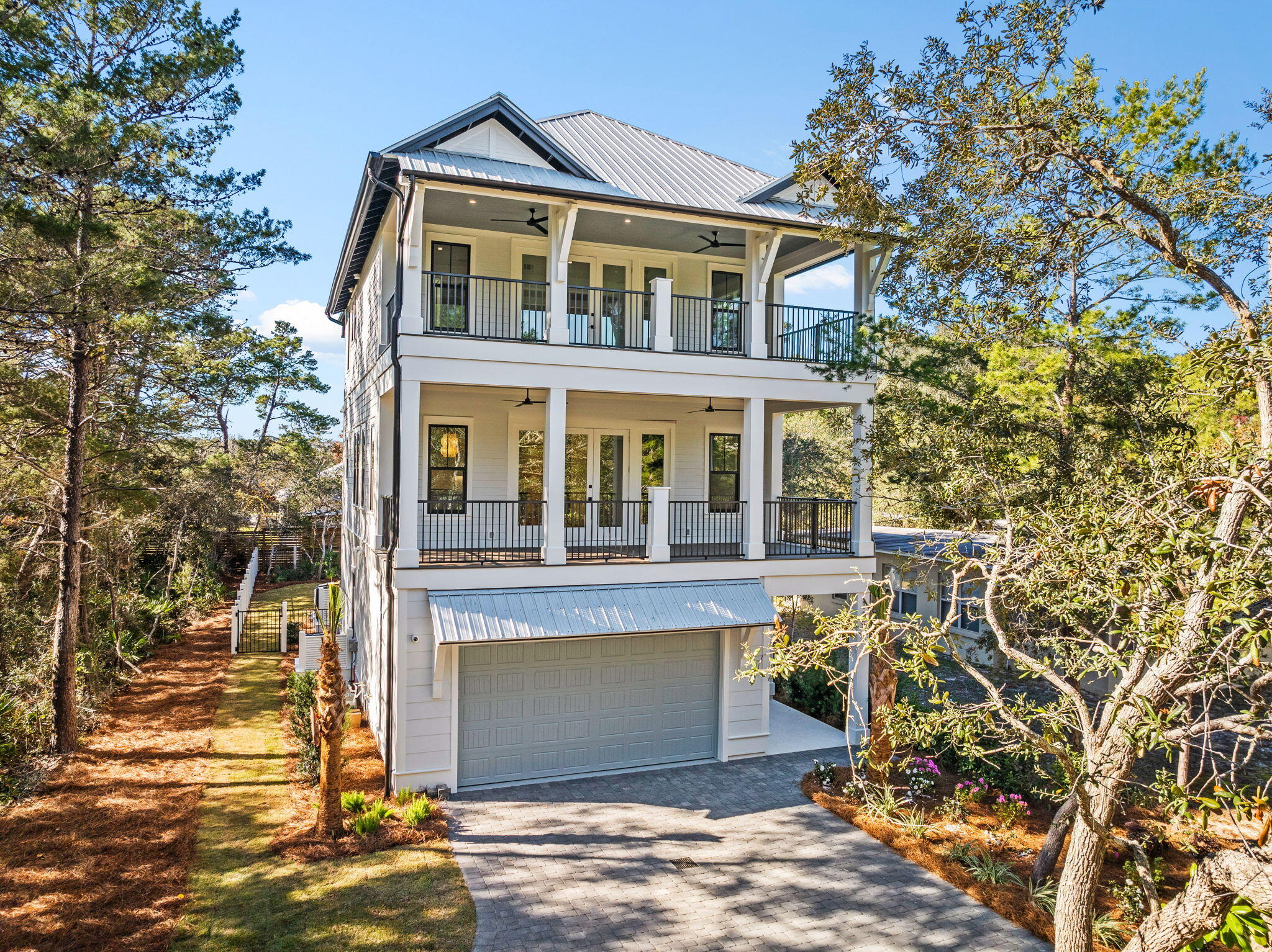 Located in the heart of Seagrove along iconic 30A, this stunning new construction home is just a half-mile from the sugar-white sands and turquoise waters of the Gulf. Ideally positioned for relaxation and entertainment, it offers easy access to public beach access, renowned dining, and the vibrant charm of 30A's coastal lifestyle.

The fenced backyard is a private oasis, featuring a luxurious saltwater pool equipped with a heater and chiller, making it perfect for year-round enjoyment. The screened-in patio takes entertaining to the next level with a cozy gas fireplace, grill, kitchen, and ample space for gathering with family and friends. Whether hosting a poolside party or enjoying a quiet evening under the stars, this outdoor space is designed for making memories. The 2-car garage,complete with epoxy floors and a built-in golf cart charger, ensures convenience meets sophistication.

Step inside, and you'll be greeted by exceptional craftsmanship and thoughtful design. The first floor boasts porcelain tile floors, solid quarter doors, and a guest bedroom with a full bath and shower. A spacious laundry room with a washer and dryer adds to the functionality, and the elevator ensures effortless access to all three levels.

The second floor features an open-concept layout ideal for entertaining. The chef's kitchen is outfitted with Thermador appliances, quartz and natural stone countertops, a pantry, and a wet bar with a fridge. The living area is bright and inviting, with shiplap accents and a seamless flow to a Trex balcony. A half bath off the living area and a private ensuite bedroom with a subway-tiled shower complete this level.

The third floor offers a tranquil retreat. The master suite boasts a spacious Trex balcony and a luxurious master bath. A charming bunkroom and a full bathroom with a subway tile shower provide space for guests or family, while a second laundry area adds convenience to the upper level.

This home is packed with premium features, including three AC units, two tankless water heaters, a security system with cameras, and an irrigation system.

Whether enjoying peaceful mornings on the balcony, entertaining by the pool, or exploring all the best of 30A, this home delivers the perfect blend of sophistication and coastal charm. Don't miss your chance to own a piece of paradise in Seagrove. Schedule your private showing today!