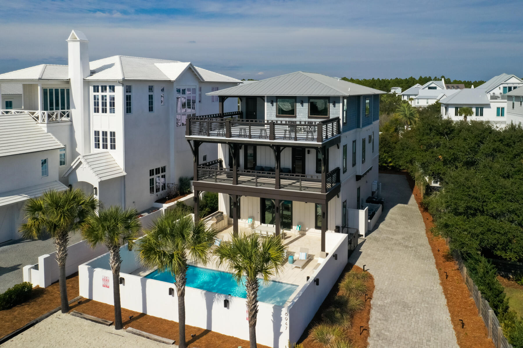 Experience refined coastal living at this exceptional residence, ideally situated within walking distance of the prestigious Alys and Rosemary Beach communities and featuring deeded beach access. Designed to accommodate up to 30 guests, the property offers spacious comfort just steps from the renowned white sands and emerald waters of 30A. The interior features elegant herringbone wood tile flooring and a chef's kitchen equipped with premium appliances, including a 48-inch gas range, custom vent hood, dual sinks and dishwashers, multiple ice makers, microwave convection ovens, and three refrigerators. High-end finishes, such as waterfall stone accents and etched mirrored cabinetry, complement the butler's pantry and generous storage, making entertaining effortless. Each of the seven bedrooms provides a private retreat with custom beds, upholstered seating, and memory foam mattresses. The third floor is dedicated to entertainment, offering dual TVs, air hockey, foosball, arcade games, and a kitchenette. Outdoor amenities include gas grills, a resort-style pool, and a fully equipped kitchen, ideal for gatherings.

With its prime location and established rental history, this property represents a compelling investment opportunity, whether for personal use or income generation. Discover the perfect blend of luxury and convenience in this coastal haven.