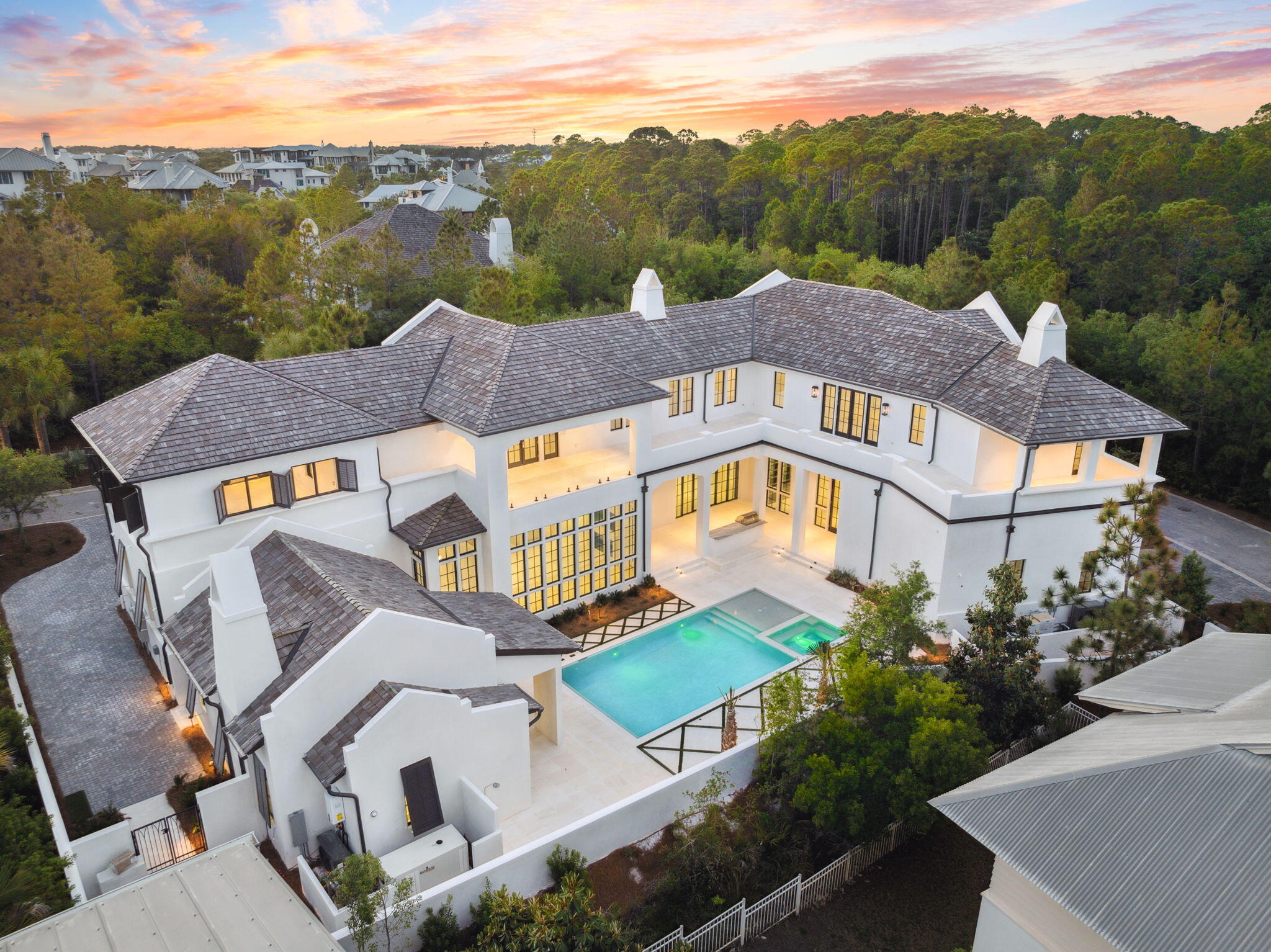 Set on the largest homesite in The Retreat, this striking new construction home offers an unmatched blend of scale, sophistication, and privacy. Positioned on a rare double lot spanning just under half an acre in one of 30A's most exclusive gated communities, this resort-style residence delivers a modern coastal lifestyle at the highest level. Encompassing over 7,000 square feet, the main home features 5 spacious bedrooms and 5.5 luxurious bathrooms, while a separate 1-bedroom, 1-bathroom carriage house near the pool offers private accommodations for guests or extended stays. From the moment you enter, it's clear no detail has been overlooked Venetian plaster walls, floor-to-ceiling windows, and sleek, modern finishes are showcased throughout the home, creating a refined yet comfortable living environment.

At the heart of the home, a showstopping double island kitchen combines custom cabinetry with high-end appliances, offering both functionality and striking design. Expansive living and dining areas open to a central courtyard, where a resort-style pool, grilling area, and ample lounging space set the stage for elevated indoor-outdoor entertaining.

Additional features include two separate garages for abundant parking and storage, along with an expansive paver motor court for guests. Every inch of this home has been thoughtfully crafted to balance beauty and utilitydelivering an extraordinary opportunity to own one of the most refined and well-designed homes in The Retreat.