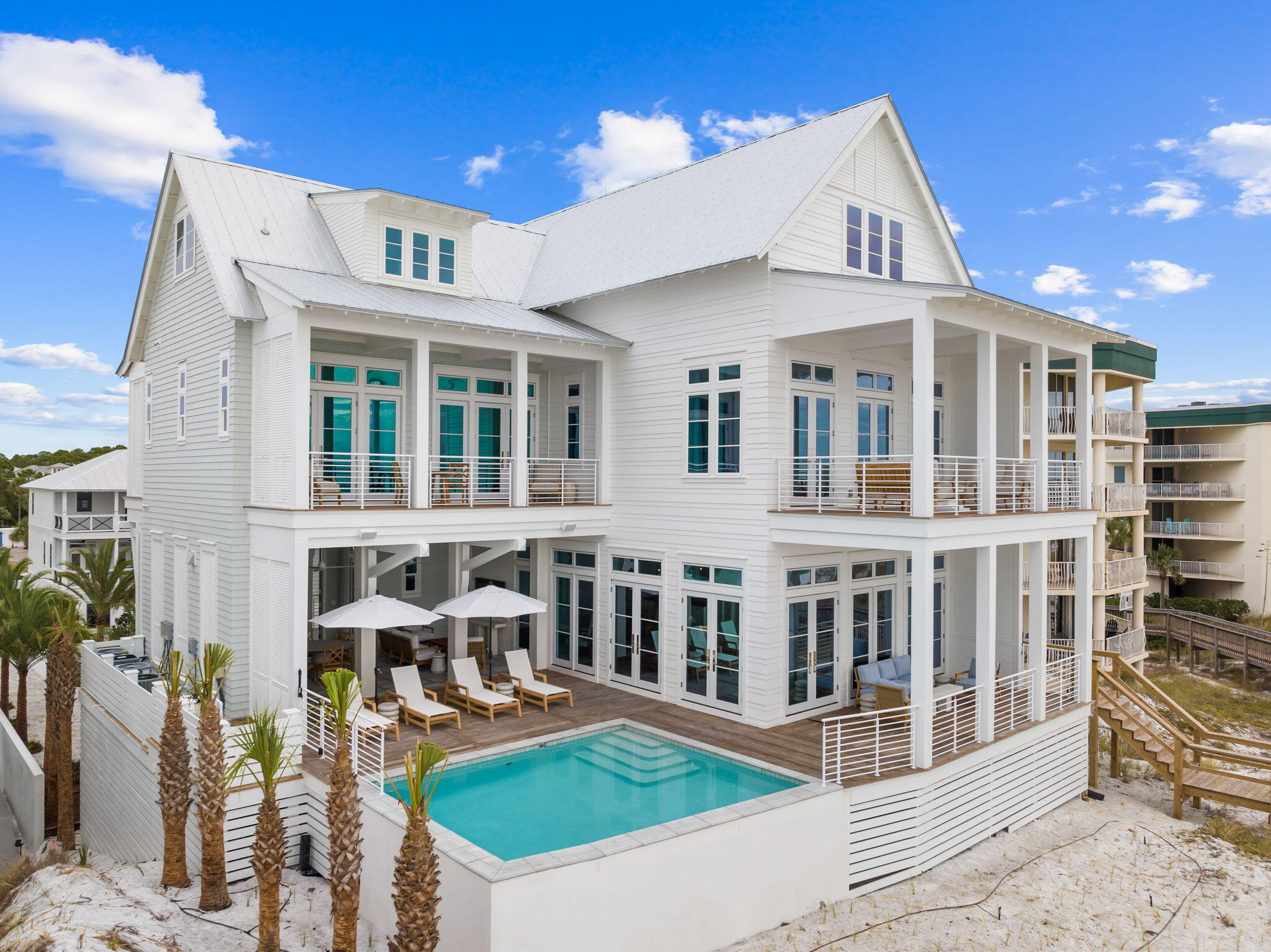 Envision the epitome of luxury and serenity at this exquisite new construction beachfront haven by renowned architect Geoff Chick perfectly situated on the pristine sands of the Emerald Coast. Boasting an impressive 7,911 square feet of elegantly designed living space and thoughtfully furnished by sought-after interior designer Ashley Gilbreath, this home is a masterpiece of comfort and sophistication in the coastal community of Seagrove Beach on 30A.
With a grand total of 8 well-appointed bedrooms plus a charming bunk room, and 8 lavish bathrooms, this property is tailored for both privacy and grand-scale entertaining. The kitchen and main living room share the 2nd floor along with the Gulf-front heated saltwater pool and outdoor kitchen with the primary bedroom on the 3rd floor. The accompanying carriage house with a 3-car garage adds a layer of convenience and opportunity for guest accommodations or a private retreat.
Every detail of this home reflects a lifestyle of uncompromising quality and leisure, from the elegant interiors to the lush outdoor living spaces. The heart of this home is directed towards the breathtaking views of the Gulf, with 68 feet of private beach frontage providing an exclusive escape to the sugar-white sands and tranquil turquoise waters. Wake up to the soothing sounds of the waves and end the day with spectacular sunset vistas from your own slice of paradise.
For those who seek relaxation without the sand, the heated saltwater pool promises year-round enjoyment, surrounded by expansive terraces that are a testament to indoor-outdoor living. A covered outdoor full kitchen ensures that al fresco dining is a breeze, allowing you to savor fresh meals under the stars with the soothing backdrop of the crashing waves.
Discover the pinnacle of Gulf front living on Scenic 30A - where luxury meets the laid-back charm of Seagrove Beach. Whether you're searching for the perfect family retreat or your next investment property, this isn't just a home; it's the start of your new coastal legacy where every moment is a treasured memory in the making.