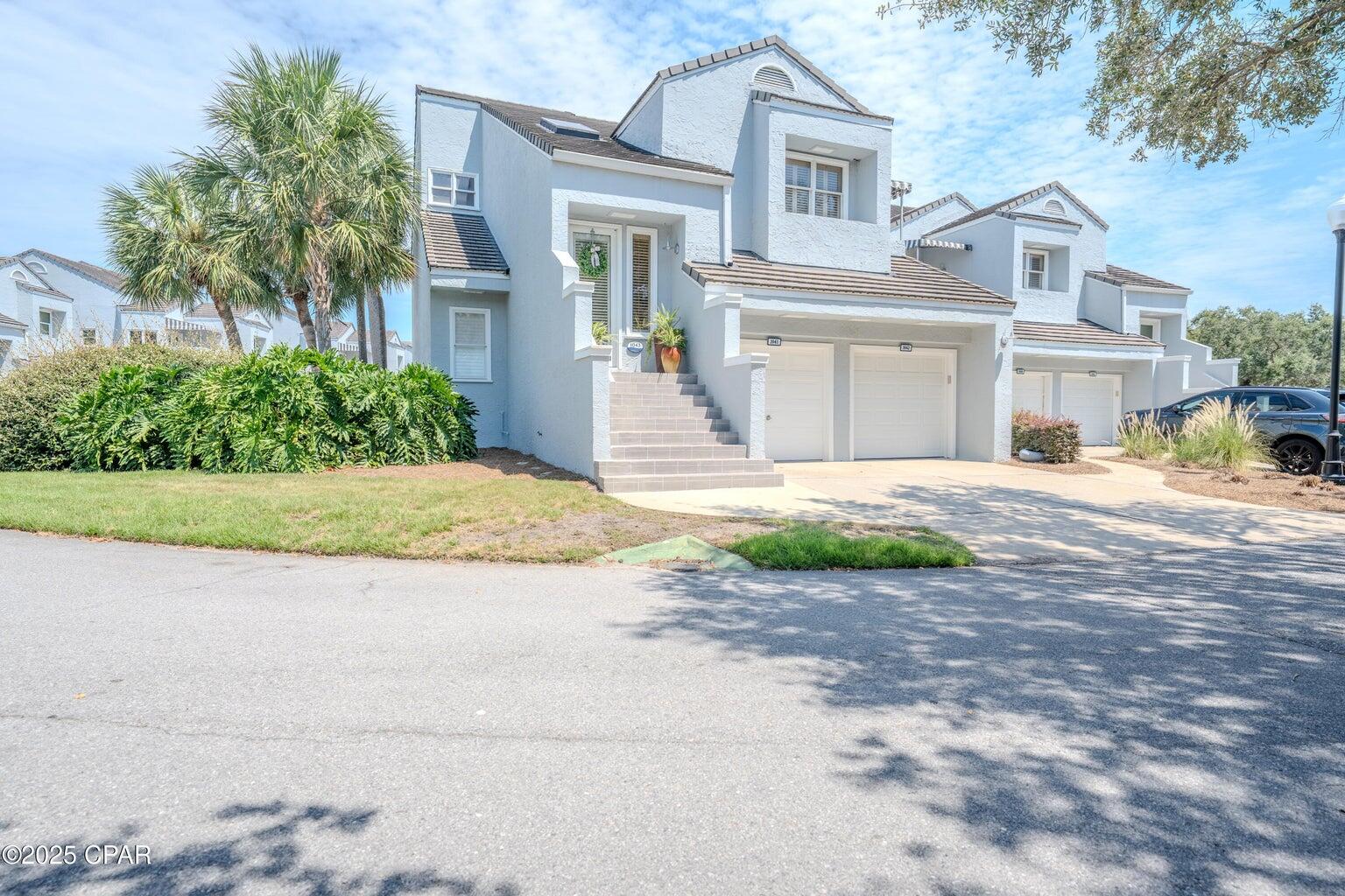 Absolutely gorgeous, 2BR/2BA at Marina Club Village—with direct views over the pool and deck and peeks of Grand Lagoon from both balconies. From the foyer, built-in bookcase/curio shelving set the tone. A dry bar adjoins the living/dining area. Throughout the home you'll find custom 3'' plantation shutters and abundant natural light. The light, airy kitchen features tile floors, updated countertops, cabinets, and sink, plus a mosaic glass tile backsplash. It opens to a cozy breakfast room with its own balcony and lagoon view—a perfect morning coffee spot. The living room offers high ceilings, a fireplace (ideal for electric logs), and large windows to the main balcony. A true split plan: the oversized guest bedroom sits opposite the private primary suite. The primary suite opens to the l large main balcony overlooking the pool and deck; its spacious bath includes double vanities, a separate jetted soaking tub and tiled shower, plus a large walk-in closet. Additional highlights: one-car garage, the unit has been wired for an in-home generator (located in the garage; configured to power most of the homeexcludes AC and stove), Community perks: residents' pool & sun deck, manicured grounds, and all the advantages of Bay Pointa guard-gated, golf-centric community with a Nicklaus-designed course, active clubs, and proximity to the full-service marina. Grocery, shopping, and some of the area's best restaurants are just outside the gates. Ideal as a full-time residence or coastal retreat.
