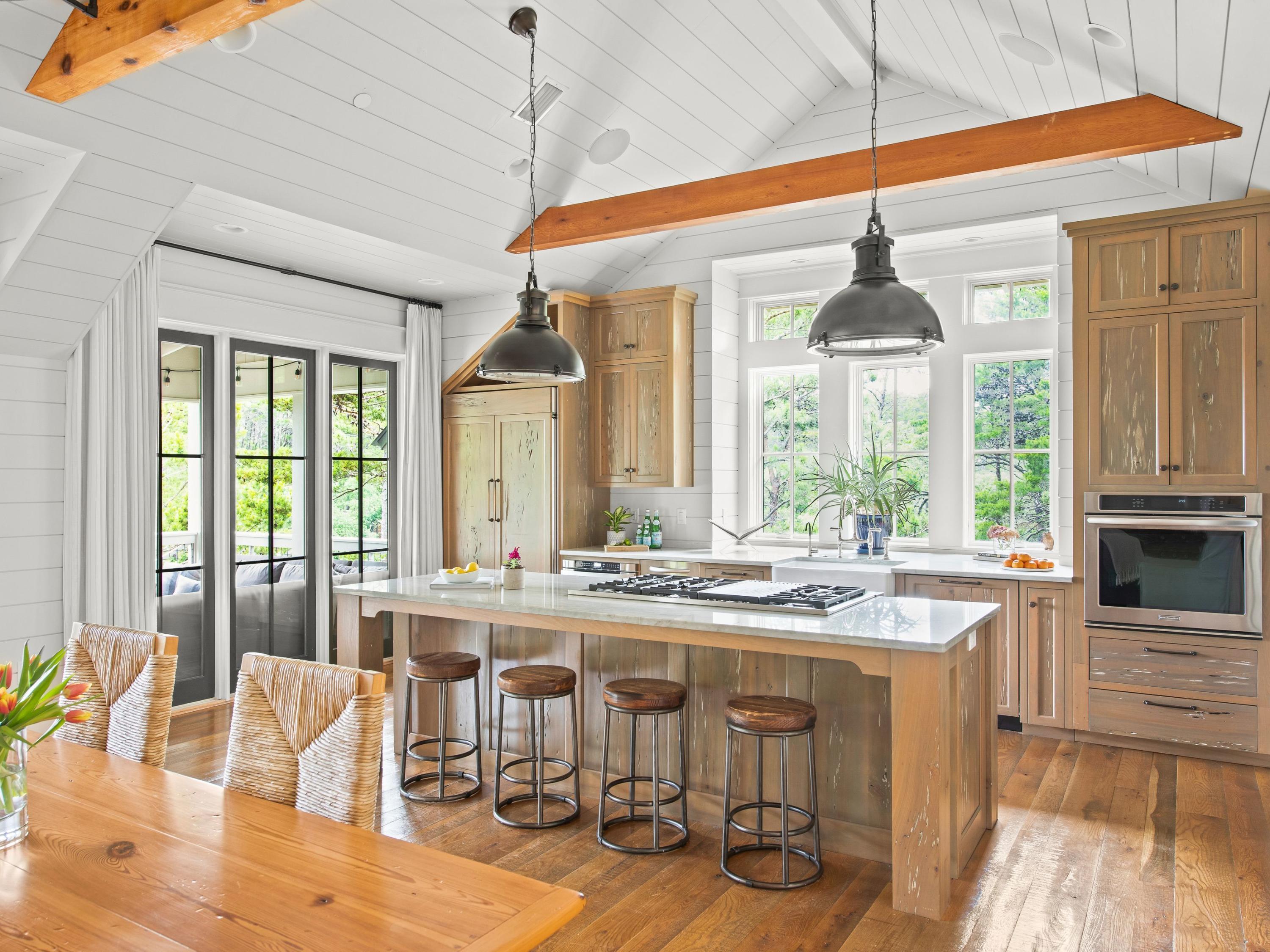 There are beach getaways and there are beach hideaways and this four-bedroom home in the rental-restricted neighborhood of Draper Lake Coastal Village is the epitome of the latter. Situated on a lush, wooded lot with views of Draper Lake, 16 Dewberry Lane was architecturally designed by Geoff Chick to convey character and to maximize relevant square footage where no space was wasted, with carefully curated decor and finishes from Urban Grace's Erika M. Powell. The first floor of this refined retreat nestled in the rolling topography of this exclusive neighborhood includes two bedrooms with ensuite baths and a bunk room with rustic, treated pecky cypress, all with rare coastal dune lake views. The home's second floor is a collection of moments you would typically find in a home with a much larger footprint, including elegant kitchen touches like a walk-in pantry, 48-in. gas range, cabinet-front appliances and gleaming natural quartzite countertops, parked under 14-ft. ceilings and accented with hand-fabricated stair railings and nickel-gap shiplap throughout. The kitchen flows into a dining space and living area, with a powder room for guests. The living area opens onto a stunning porch with gas lanterns, water views and warm Southern breezes.

The entry into the master suite is lined with a built-in bookcase. Veer to your left and you'll be acquainted with a private office or study nook, a bath with tub and walk-in shower featuring basket weave and Carrara marble. The master bedroom is replete with natural light. Outside the home sits a large storage shed designed to look like an extension of the home and a two-car garage.

Draper Lake Coastal Village is an experience not to be missed. At once wholly Adirondack in style with walking trails and green space, it is also wholly South Walton: A short walk with a paddleboard to launch in Draper Lake; minutes to the beach; and, easy access to the world-renowned shops and restaurants of Scenic Highway 30A.