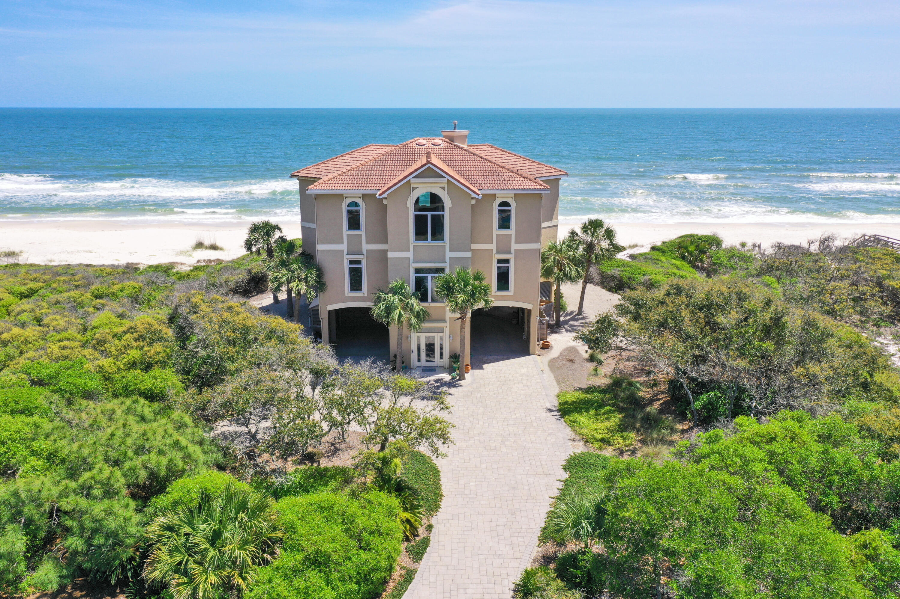 This remarkable 5 BR, 3.5 BA gulf front home is a custom built dream home located in the SGI Plantation. By far one of the most spectacular views on the island! ''Windsong'' is graced with soaring ceilings & enormous windows with 180° panoramic views overlooking the Gulf of Mexico. The spacious layout affords ultimate privacy w/ four bedrooms on the 2nd level w/ their own living space, 2 large full bathrooms & a hobby/office niche. Wide open deck w/ swim spa & hot tub overlooks the beach! A large primary bedroom, on the third level, is the ultimate retreat w/ built-in custom cabinetry & a relaxing spa-like bathroom. Luxurious chef's kitchen with state-of-the-art appliances & premium finishes.   Interior elevator too!