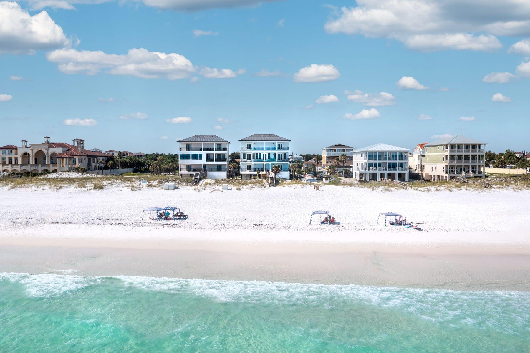 Prominently seated atop the sugar white sand dunes of Miramar Beach, this artistically constructed Gulf front masterpiece awaits. Perfect for those longing for a highly amenitized second home or portfolio property, this beach retreat is perfect for large groups, family reunions or beach weddings. Outfitted in luxurious finishes such as Quartz countertops and designer tile throughout, the perfect elevated touches assist in elevating the experiences by all who spend time within this expansive property's walls. Designed to capture the breathtaking sights of the Gulf of Mexico only footsteps away, five of the property's eight bedrooms offer direct Gulf views, sure to charm guests and owners alike. An uncrowded beach will ensure you get front row access to the sparking emerald waters of the Gulf coast. Open living spaces and warm coastal decor pair idyllically with the crisp contemporary design touches seen across all three levels of this beach retreat. The chef's kitchen is appointed with Dacor stainless appliances including a gas stove, to offer additional touches of quality. A Gulf front pool provides the perfect locale to retreat from the sand and sun for additional relaxation and time together with friends and family. Covered parking, a private elevator, room for cookouts, a boardwalk with outdoor shower, along with the enchanting coastline of the Emerald Coast, make this nearly 4,500 square foot home a vacation experience to remember.