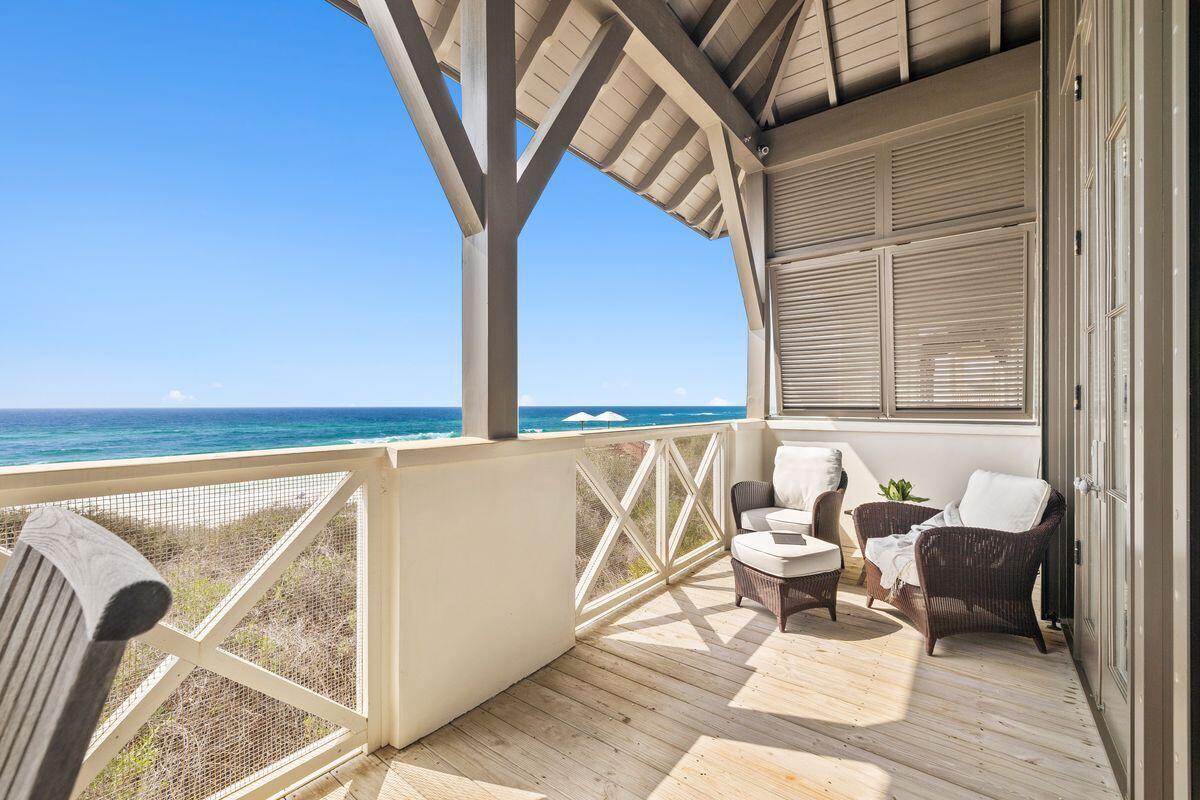 Offering gulf front living and panoramic vistas in Rosemary Beach, 26 Atwoods captures the essence of coastal living. Upon arrival, the home's exterior is graced with beautiful jasmine vine, while the courtyard living space is a beautiful prelude to the bright coastal interiors within this captivating gulf front gem.

The first level primary suite provides a cozy fireplace and large outdoor porch for private moments listening to the gulf and contemplating the day. Level 1 also includes a guest bedroom with ensuite bath and laundry area. Ascending to the second level, stunning gulf views and natural light flood the living area and kitchen. Three sets of french doors with transoms create a wall of windows to highlight the emerald waters and majestic dunes. A second fireplace in the living area along with vaulted ceilings and nickel gap walls are a gracious backdrop to the views outside. Head outside to enjoy the grand porch that spans the width of the home. A 3rd floor loft tops the home with a queen bed and full bath. The whimsical carriage home adds another bedroom with additional kitchen, laundry and bathroom. Designed by architect Ken Tate and featured in Coastal Living magazine, this inspired home captures the essence of the Rosemary Beach lifestyle.