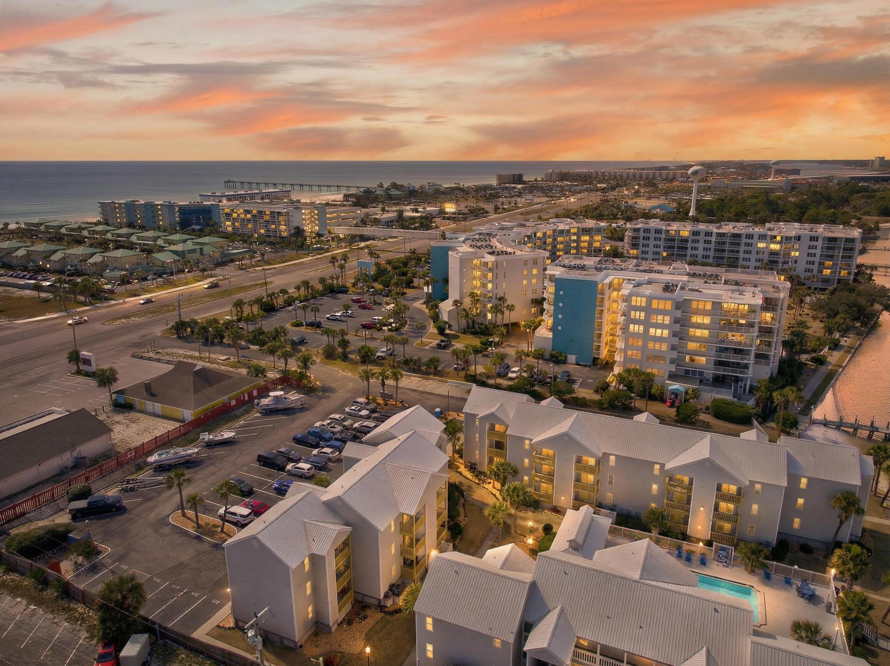 Beach in the front. Bay in the back.

Welcome to Hermitage Condominiums on Okaloosa Island — where you truly get the best of both worlds. This top-floor, corner-positioned unit sits closest to the bay, delivering panoramic views of Choctawhatchee Bay and front-row seats to unforgettable sunsets. Directly across the street, you'll find John Beasley Park and public beach access to the sugar-white sands and emerald waters that make this stretch of coastline famous. Spend your mornings on the Gulf, your afternoons by the bayfront pool, and your evenings watching the sunset from your private balcony. Not a bad routine.

Inside, the unit has been thoughtfully renovated with a clean coastal design and comes fully furnished  ready to enjoy or rent immediately. The living room couch is a brand new queen sleeper sofa. The two-bedroom layout offers private bathrooms for each bedroom, ideal for guests. The guest room features a queen bed plus a custom-built twin above, maximizing sleeping capacity without sacrificing comfort.

Water views extend from the living room, primary bedroom, and balcony  because if you're buying on the Island, you should actually see the water.

Upgrades include:

Luxury vinyl plank flooring
Granite countertops
Shaker-style cabinetry
Stainless steel appliances
Updated HVAC (2025)
Kitchen remodel (2017)
Water heater (2016)
Washer & Dryer (2025)
BRAND NEW BALCONY (2026)

Location? You're in the sweet spot. Walk to the Okaloosa Island Boardwalk, the fishing pier, Gulfarium Marine Adventure Park, Wild Willie's Adventure Zone, and local favorite Rick's on the Island via the scenic inlet path. The new 122-slip marina just east of the building adds even more long-term value to this bayfront address.

Hermitage amenities include:

Large bayfront pool
Dock and fishing pier
BBQ areas
Assigned parking
Pet walking area
Bayfront seating areas

Whether you're looking for a personal getaway, a rental performer, or both  this one checks the boxes. Beach access. Bay views. Walkability. Income potential.