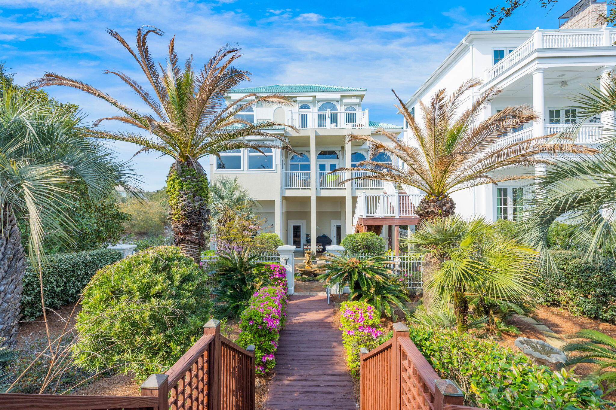 Discover an exquisite coastal retreat nestled in the gated community of Seclusion Dunes, where tranquility meets luxury. This stunning residence boasts 3,300 square feet of thoughtfully designed living space and an enviable beachfront location. Situated on a unique lot with direct southern exposure facing Deer Lake State Park, the property offers unparalleled views and a serene backdrop that is truly unmatched.

With four spacious bedrooms and two and a half baths, this home is perfect for both relaxation and entertaining. The custom kitchen is complete with high-end appliances and ample counter space, making it ideal for hosting gatherings. The newly designed master bathroom offers a spa-like experience, complemented by custom closets crafted by California Closets, ensuring optimal organization and style.

Enjoy the cozy ambiance of two gas fireplaces, perfect for those cooler evenings. The home's design emphasizes outdoor living, featuring a boardwalk that leads directly to the beach, along with lush, beautifully landscaped gardens adorned with two exterior fountains. The driveway leads to a three-car garage, providing ample space for vehicles, storage, and accommodating a 20-foot boat with ease.

The community's quiet atmosphere is a welcome escape from the vibrancy of 30A, allowing for peaceful strolls along sidewalks, nature trails, and through the picturesque courtyard.

Experience the epitome of coastal luxury living at 490 Beachfront Trail, where every detail has been meticulously crafted to offer comfort and sophistication in a serene, secluded setting. Don't miss your chance to own this extraordinary part of paradise.