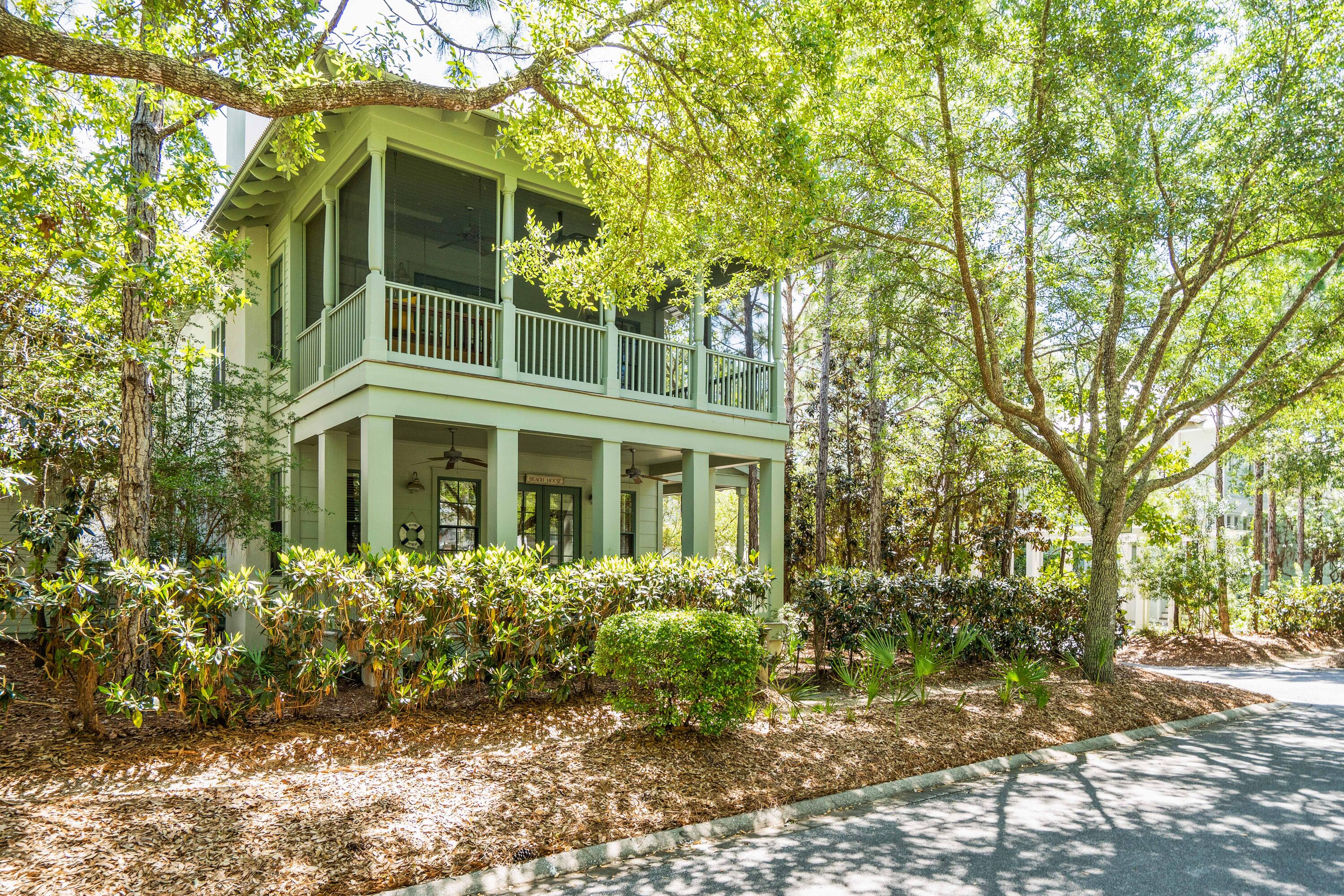 Nestled on a 8700 sq ft corner lot in Watercolor, this lovely 4 bed/4 bath home is just steps away from Camp Watercolor. This meticulously maintained, one owner home, has never been rented but has strong rental projections. The shaded outdoor patio has a brick fireplace with a grilling area for outdoor entertaining and there is over 1300 sq ft of covered porches to relax on.  The first floor has open floor plan kitchen/living with a fireplace, window seating and 3 covered porches!  There is one bed/bath on the first floor. The second floor has additional beds/baths, a small nook that makes for a great office and 2 screened porches. The master suite includes a private screened porch with daybed and ensuite bath. There is pre-approval from DRB to build a Carriage House on this large lot. There is also an enclosed outdoor shower and additional storage area.