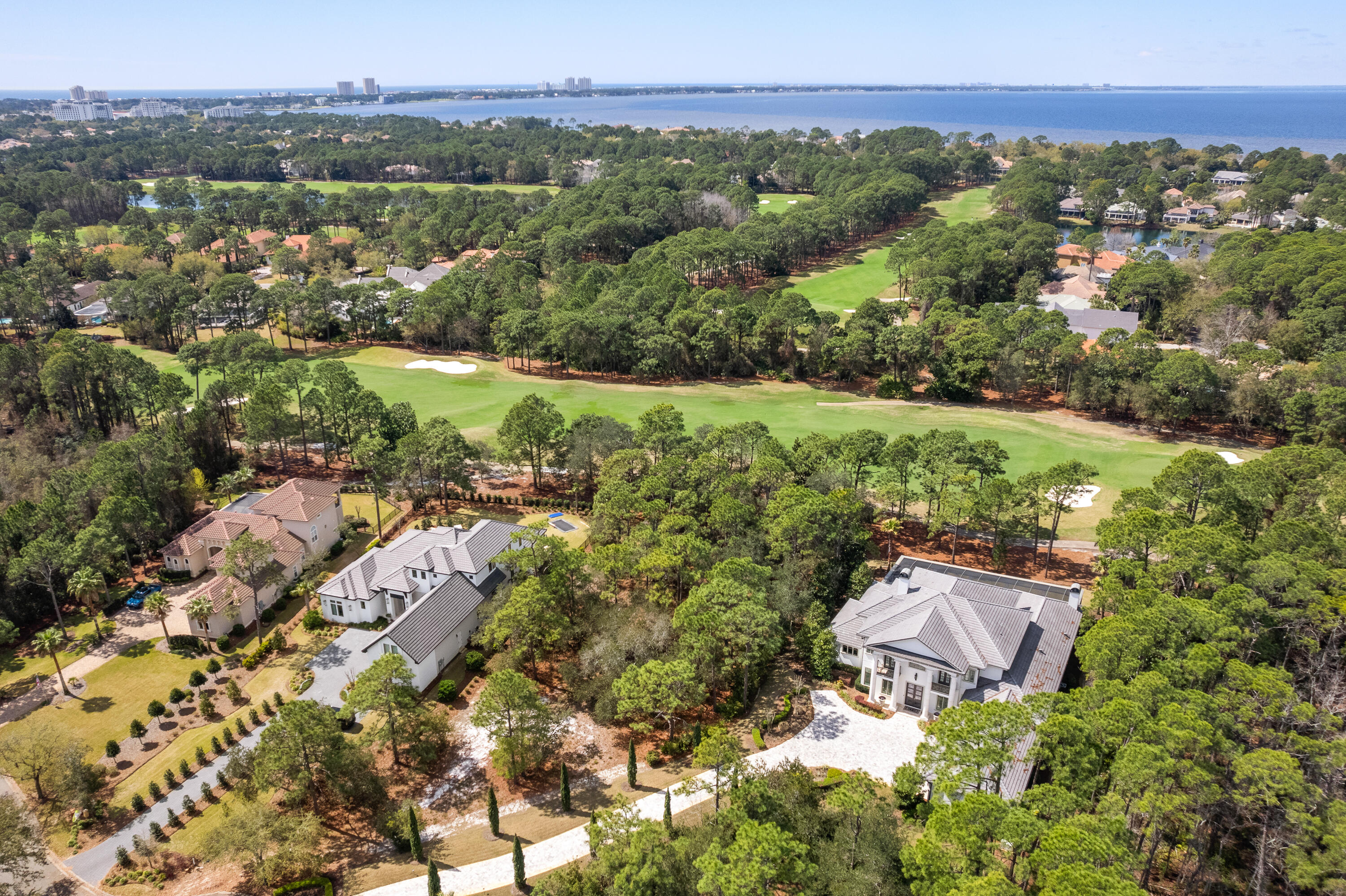 *** New Compelling Price ***Welcome to 3570 Preserve Drive, a luxurious masterpiece, perfectly nestled on an estate size lot in the highly coveted double gated, non-rental neighborhood of Burnt Pine at Sandestin Golf and Beach Resort.  Originally constructed as a personal residence by one of the most prominent home builders in the Southeast, the current owners have elevated its design in collaboration with Christopher K. Coffin Design out of Scottsdale, Arizona.
 
Exquisite design materials and the finest of finishes have been selected throughout the home.  The exemplary architectural design and impeccable attention to detail found in this extraordinary property will leave a lasting impression, as this home is truly the only one of its kind.  With sweeping golf course views, poised on a cul-de-sac home site alon the 4th green of the Burnt Pine Golf Course, at just under 7,000 square feet of living space, this residence is a real gem.

The main level features a stunning, welcoming foyer entrance with soaring ceilings, a custom Dennis & Leen Palace Chandelier, along with a beautiful winding staircase. The formal dining area and inviting open living area flows seamlessly to the expansive outdoor living area, resort style pool and hot tub. Upon entering, prepare to be captivated by the artistic design found throughout this special offering. An entertainer's dream, created to host the most extravagant gatherings for extended family and guests. The impeccable custom kitchen is anchored with an expansive island boasting a Calcutta marble top, and features an abundance of cabinetry, a Francois & Co. pewter range hood banded with antique brass straps, backsplash tile with brass shelving, Shaw farmhouse sink, Waterstone faucet and professional grade appliances. Adjacent to the kitchen is a custom wine cellar which accommodates over 700 bottles finished with Phillip Jefferies Gold Leaf Wallpaper and custom Paul Ferrante Lantern, all accessed through an impressive steel and glass door. In the nearby Butler's Pantry, you'll find additional beautiful custom cabinetry complementing the kitchen with custom antique mirrored tile, and quartz countertop.

The unique amenities offered in this beauty extend on the main level, where you will find the kitchen flanked by an oversized Florida Room which also leads to the pool and screened lanai. The Florida Room was designed with flexibility in mind, as it is lined with patio doors so that it can be utilized for maximum enjoyment year around. With an abundance of natural light, the Florida Room houses a stunning separate bar area complete with sink, ice maker, dishwasher, and a comfortable living space with a cozy fireplace, and a half bath.

The master suite is also on the main level, and it is the epitome of elegance and tranquility, with wide plank wood floors and custom Dennis & Leen Chandelier in the bedroom. Master bathroom suite features beautiful marble finishes throughout. Dual vanities, make-up counter, and separate his and her walk-in closets. On the main level, you will also find an office, complete with beautiful custom built-in cabinetry, as well as an additional bedroom with ensuite bath providing for the ultimate guest experience.

The second level hosts three additional bedrooms, each with beautifully appointed ensuite baths, as well as a spacious, comfortable living area, separate washer and dryer, and outdoor balcony living area with panoramic views.

This stately offering is complete with three full car garage bays, built in garage storage, lush landscaping, and an abundance of highlights which remain to be mentioned. It is the pinnacle of luxury living along the Emerald Coast, tucked amongst the most serene surroundings, yet conveniently located within excellent proximity to all the amenities that the area has to offer. Available for private showings by appointment only.