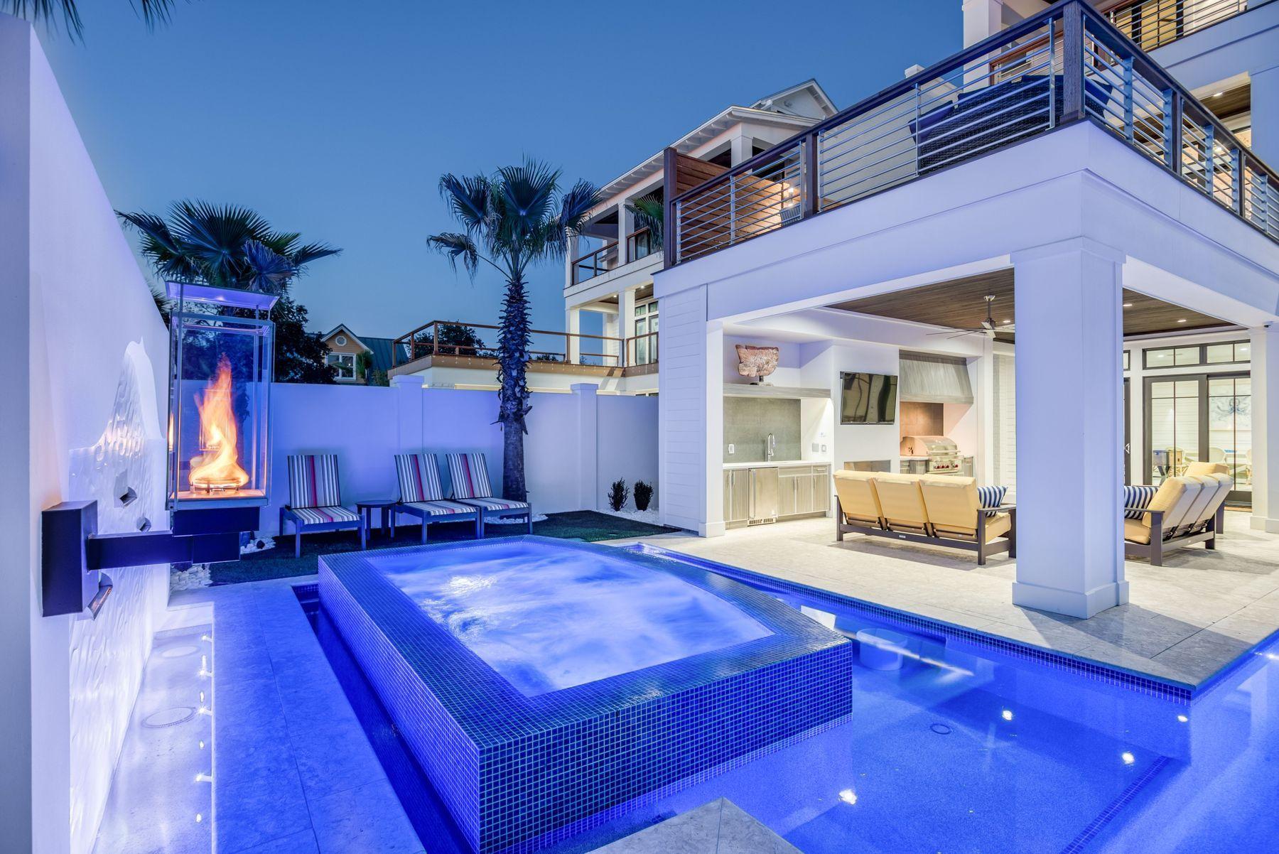 Noteworthy coastal design and exemplary architectural significance beautifully characterize the bespoke beachside retreat of Park Row at Crystal Beach primely situated in the heart of Destin, Florida. This masterfully planned development was envisioned and executed with the utmost quality while remaining uncompromised in optimal function and lifestyle taking full advantage of premium positioning near an exceptional beach access and world class restaurants including Camilles at Crystal Beach, Henderson Beach Resort & Spa as well as the Destin Commons, Whole Foods & Legendary Marina. Captivating white-washed brick parapet walls and caribbean-style landscaping offer a striking contrast yielding to a welcoming sense of arrival defined by an expansive promenade of belgian cobblestone pavers, low maintenance synthetic turf and hand selected sylvester palm trees. This 9 bedroom resort-style residence has been optimally designed for entertaining and would be an ideal second home or outstanding short term rental with permanent occupancy granted for 33 people and over $340,000 in projected gross annual rental revenue. The contemporary open floor plan and strategic positioning of each structure allows for captivating gulf views providing unparalleled amenities including a 50,000 gallon private resort-style pool area complete with a sunken swim-up bar as well as an adjoining spa, in-pool concrete picnic table, ambient gas lanterns & covered outdoor summer kitchen offering a linear gas fireplace and stainless built-in grill. The outdoor amenities also include sprawling covered porches as well as a private sun deck overlooking the pool area with ample space to enjoy the Florida sunshine and afternoon seabreeze. This home was designed to maximize functionality and finely appointed with chic contemporary finishes while affording exceptional comfort & living space. Notable features include multiple indoor and outdoor living areas, private commercial grade elevator, separate two car garage for owner's storage or guest storage, 8 parking places, dual master suites with gulf views, built-in pinterest worthy bunk beds, indoor and outdoor surround sound system as well as security cameras for privacy. The first floor layout boasts a spacious bunkroom, laundry area, large bedroom suite with ensuite full bath as well as an expansive game room complete with pool table & built in wet bar which flows seamlessly to the outdoor resort amenities. The second floor is the focal point of indoor living space with a sleek contemporary living room featuring pecky cypress ceilings, floor to ceiling windows to soak in natural light, linear gas fireplace with stone surround and open to the chef's kitchen & dining room for optimal flow. The finely appointed open-concept kitchen features floor-to-ceiling custom cabinetry, hand built custom hood perfectly framing the 60" Wolf professional series gas range, oversized refrigerator and ample storage anchored by a massive center island crowned with gorgeous quartz countertops and a Kholer stages series stainless sink. The second floor also features three full bedrooms with ensuite bathrooms, convenient half bath as well as access to the second story outdoor living area overlooking the lagoon style pool. The third floor features a completely separate bunk room and kids playroom with it's own full laundry area and ensuite bathroom. The dual master suites also occupy the third level with  spacious covered porches, private coffee & wine bar, spa-like master bathrooms with marble flooring and accents as well as a walk-in shower, free standing tub and spacious closet. The fourth story viewing deck was designed to maximize the incredible gulf and western oriented views that surround this prestigious property. Park Row at Crystal Beach conveys fully furnished and turn-key offering a direct beach access point steps from the home and is centrally located near Destin's world class golfing, dining, shopping, boating & entertainment.