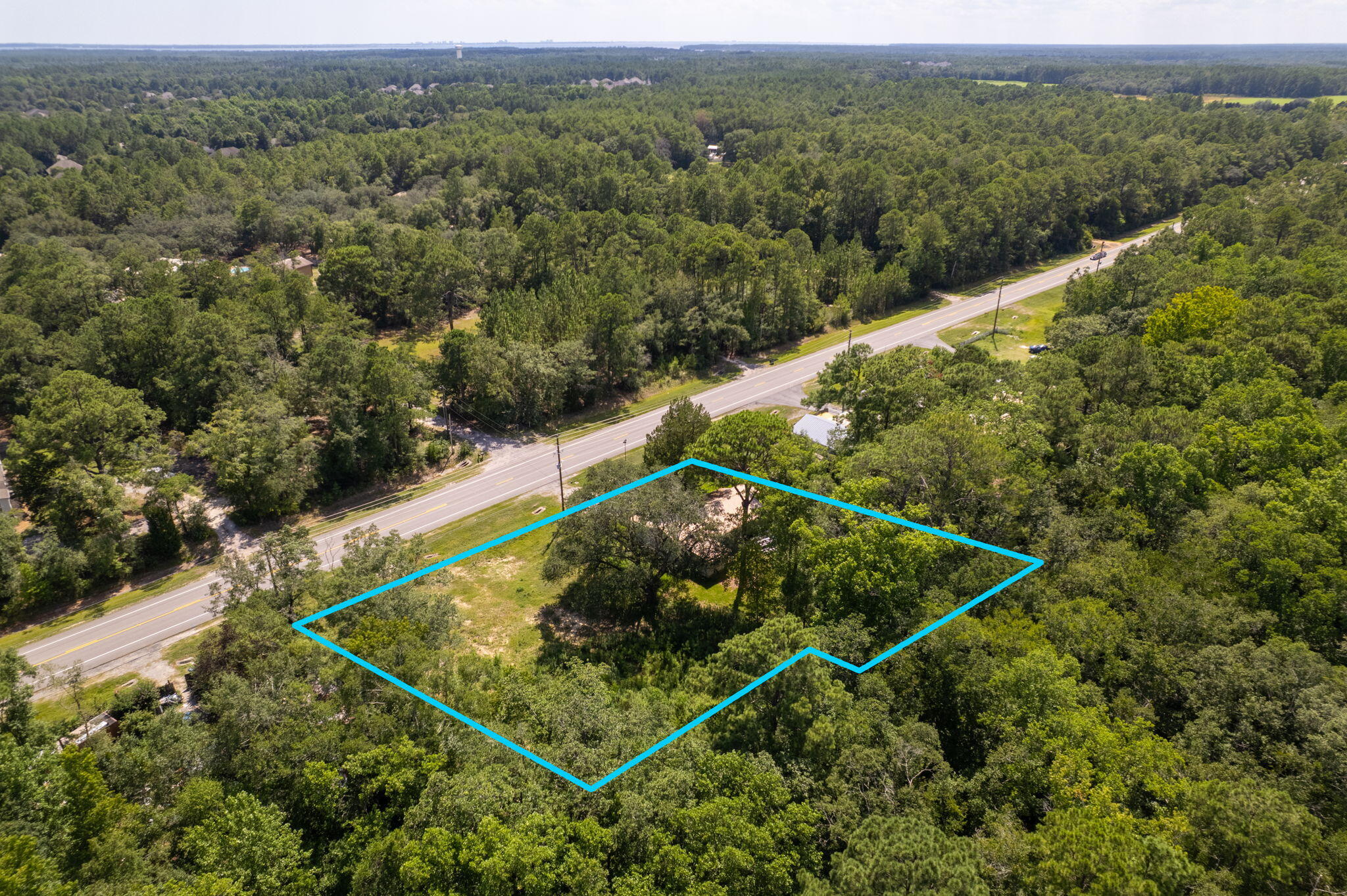 This .54 acre lot and the adjacent .5 acre lot to the west are being sold as one combined parcel. The two parcels combined provide for over 234' of frontage on the heavily trafficked Hwy 20