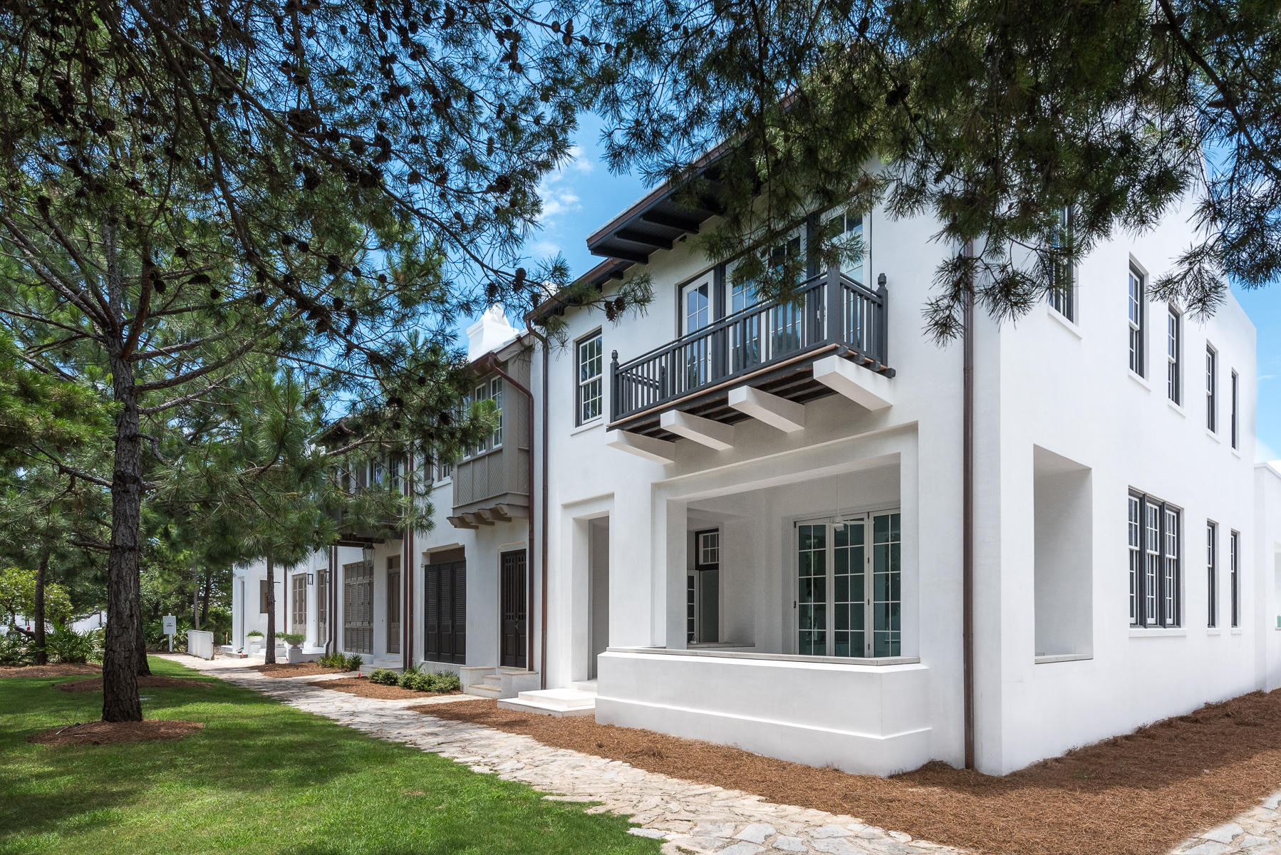 This home designed by Khoury-Vogt Architect Team, was carefully crafted with the Alys Beach unrivaled sense of escape. Positioned in the secluded greenery of Arboleda Park, this home features a beautiful open living space that flows seamlessly to the exterior courtyard.
Other intriguing qualities of this home include a Gourmet kitchen and butler's area that will gratify the chef of the family and satisfy the savviest of culinary artists. This home has walls covered with Venetian Plaster, a supplementary private courtyard loggia with a pool and grill area. The upper sleeping level boasts 2 Master bedroom suites; one with a midnight kitchen and study area and the 2nd overlooking the green space of Arboleda Park. 2 additional bedrooms, bunk area and media room round off the upper level of the home. For exquisite beach living at it's paramount - buying a second home just got effortless.