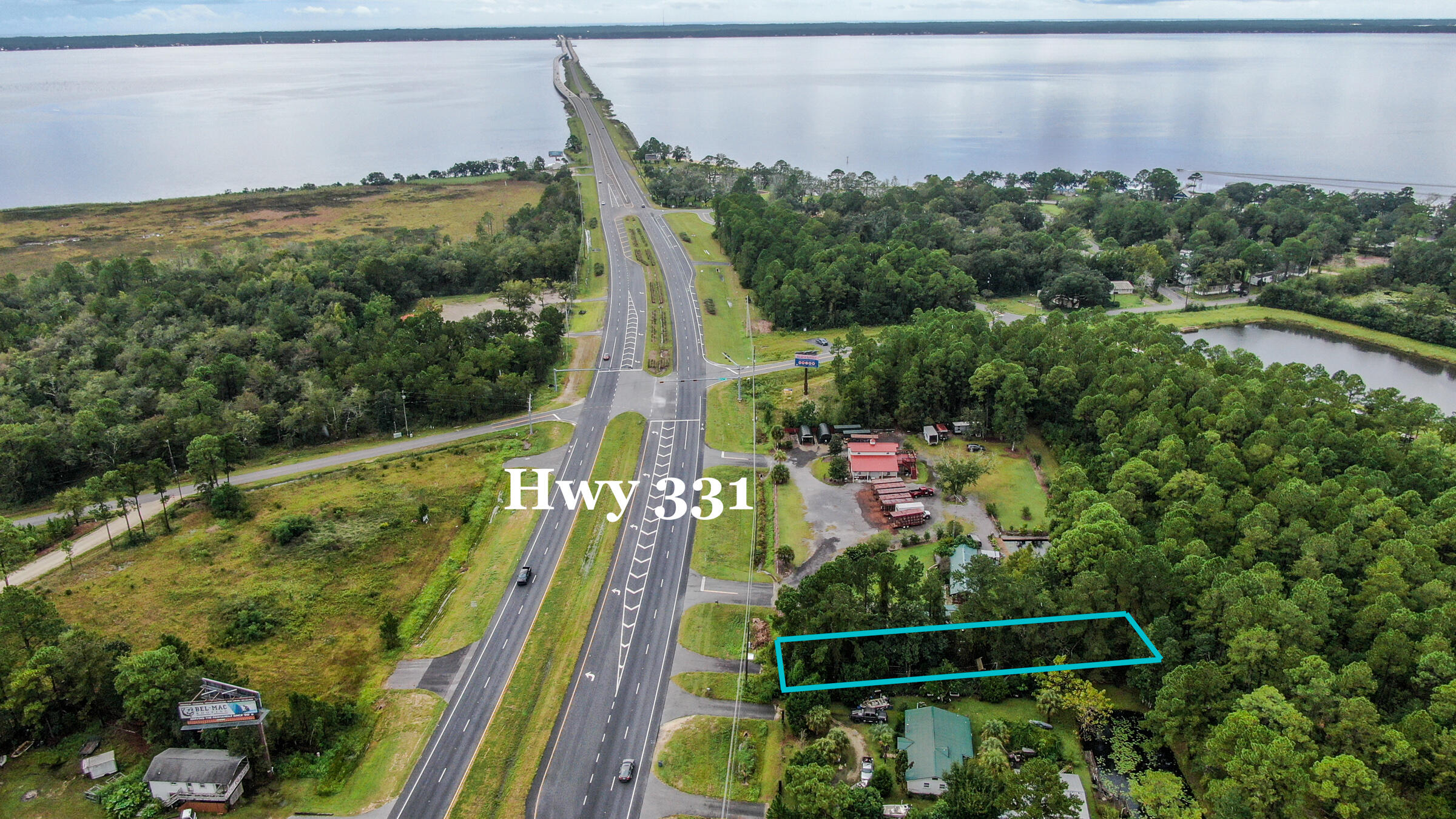 This vacant land is just over the 331 Bridge a mile in to Freeport on the south driving direction of Hwy 331.     Many commercial business options such as plant nursery, retail,  small restaurant, warehouse/storage, business/residential structure, and more. Zoned Rural Village and General Commercial.  Seller will have land cleared. Has Development Order for heavy equiment business, landscaping, small building/business.