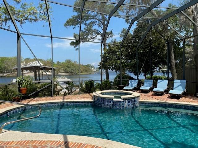 Beautiful deep water bayou home conveniently located on 110' Hewitt Bayou close to Sacred Heart Hospital and Grande Blvd. This spacious 4 bedroom, 4 bath home with master on 1st floor has 12' ceilings in living, dining and master. Shiplap walls, solid wood flooring, and solid beam columns throughout.  2600 sf dock with 2 slips and lifs. Full house generator. Oversized garage with custom shelving and epoxy flooring. New Subzero, new icemaker and new upstairs AC in the last year. 
Enjoy gorgeous views of the bayou, Choctawhatchee Bay, and the intercoastal beyond. Wonderful porches front and back. Large pool with screened enclosure. Beautiful live oaks and yard. (It was nominated for yard of the yr. by the Green Thumb Garden Club!) Wonderful large open porch upstairs with swinging bed.  Guest bedroom and bath and another living area, bar and small office complete the upstairs area. Office could be a perfect bunkroom! 
This is a must see property! if you've ever dreamed of living on the bayou with these views, this is it!