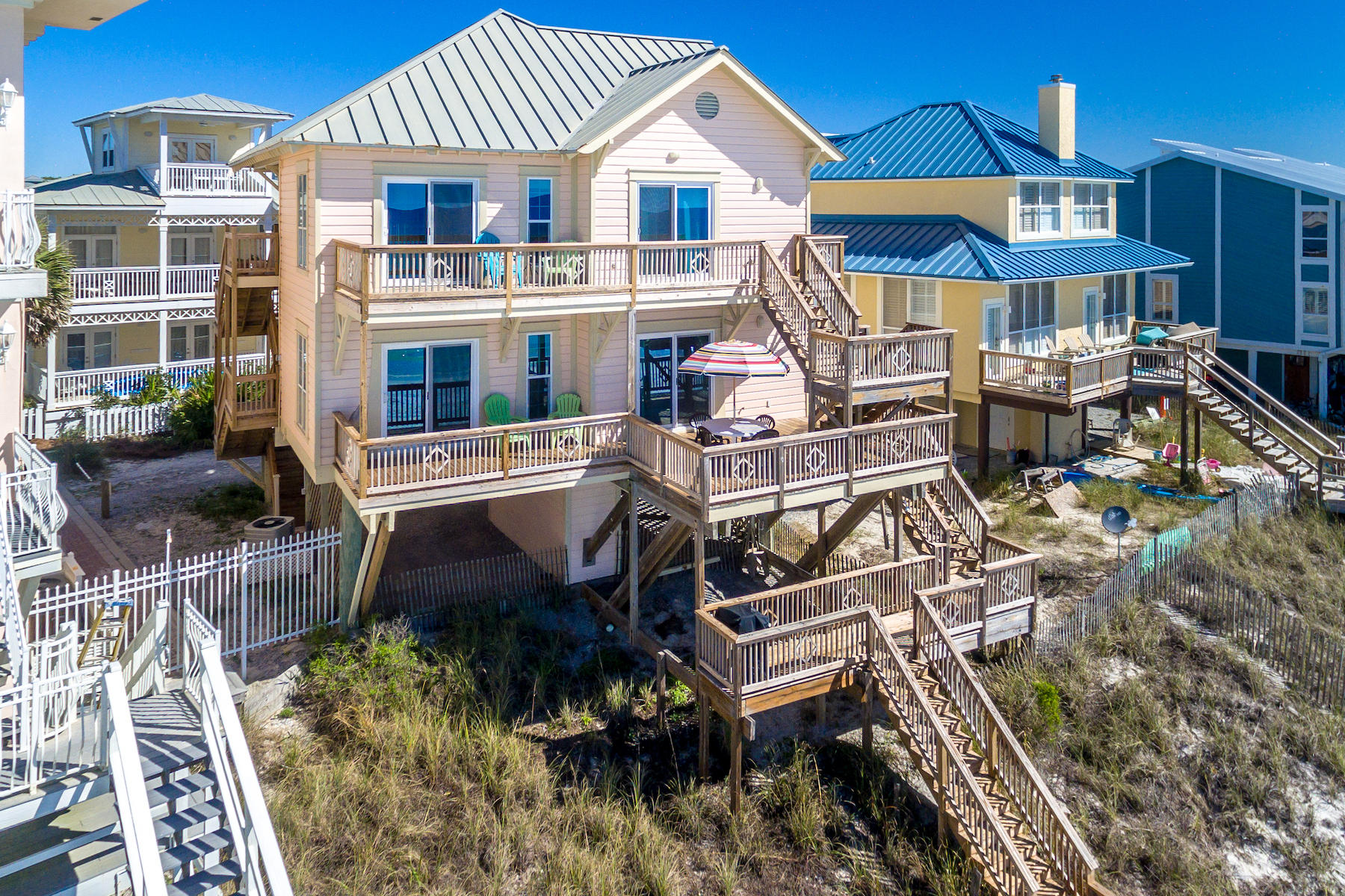Outstanding Gulf Front duplex in desirable Eastern Lake area off County Hwy 30A. Dolphin Watch is appropriately named, with gulf views from every room. This property offers the best of easy beach living with ultimate privacy. The beach house is at the dead end of secluded Eastern Lake Road. Walk out your private beach boardwalk onto the sugar white sand of the Emerald Coast. Just a short walk down the beach is Eastern Lake, one of the 15 rare Coastal Dune Lakes in South Walton County--and only found in a handful of places in the world. The interior and exterior of this duplex have been very well maintained, and some major updates have already been made, such as new decking, new AC units, and more. This beach house only needs a few cosmetic updates to become an ultimate beachfront getaway! Both units in this gulf front duplex offer gulf views from the living area, kitchen, master bedrooms, master bathrooms, and guest bedrooms. 3 levels of new decking offer amazing views of the beautiful Emerald Coast, perfect for sunset entertaining. The private boardwalk takes you straight onto the beautiful white beaches, and upon return enjoy the outdoor shower on the first level deck to rinse the sand off before you head inside. Just above the covered parking, each separate unit features an open concept living area with the kitchen overlooking the dining and living areas, crown molding throughout, and brand new sliding glass doors out to the decks. Wake up to a view of the emerald green surf in both gulf front master bedrooms, also with brand new sliding glass doors. Both masters also have custom walk in closets. The first floor master bath features marble counters, an over-sized marble walk in shower, and a vanity area with seating. The second floor master bath features marble counters and a large marble jetted tub/shower combo. The first floor guest bedrooms both offer queen beds and custom closets in each, and one guest room has built-in twin cantilever bunk beds for 2 extra guests. The second floor guest bedrooms both offer queen beds and custom closets in each. The guest bathrooms in each unit feature marble countertops and tub/showers. The kitchens both upstairs and down have natural light from windows, and both offer a breakfast bar and pantry. Each unit has its own laundry closet with washer, dryer, and custom shelving, as well as a separate owners/linen closet. A fantastic highlight of the 2nd floor unit is the vaulted ceilings and the large loft area, featuring 2 twin beds, a full bath with walk in shower, a storage closet and a large seating/lounge area. Lots of natural light in this loft area with several windows. Additionally, owners installed a seawall with a cost of over $25k. Whether looking for a primary residence, second home, vacation rental or all of the above, Dolphin Watch offers endless possibilities and lifelong memories for generations to come.