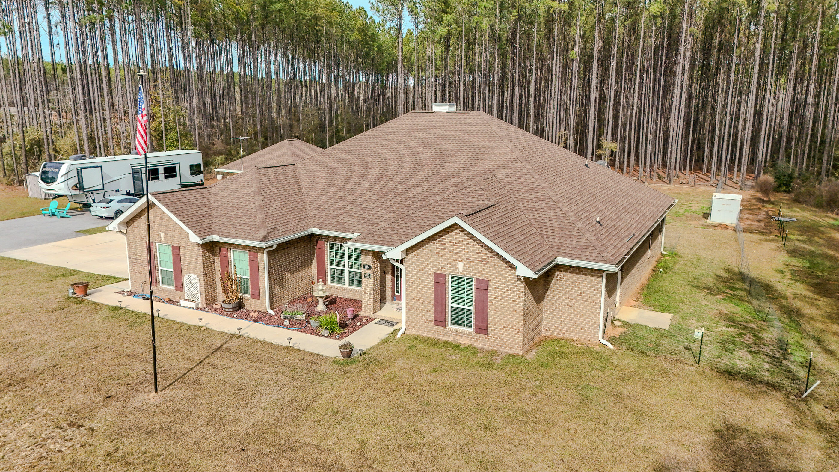 Nestled in a desirable community, this brick 4-bedroom, 2.5-bath home sitting on 10.22 acres built in 2022 blends modern convenience with classic charm. It offers a two-car attached garage plus an additional two-car detached garage, and a front fence lined with crape myrtles for instant curb appeal. Inside, the kitchen boasts stainless steel appliances and opens to a family room featuring an electric fireplace, exposed columns, and a 9-foot tray ceiling. The master suite also showcases a 9-foot tray ceiling, and its walk-in closet wraps around behind and beside the garden tub. Two bedrooms share a convenient jack-and-jill bathroom, while all bedrooms include walk-in closets. The home is finished with tile and hardwood flooring throughout. Extras include a storage shed with power & an RV hookup area with septic.