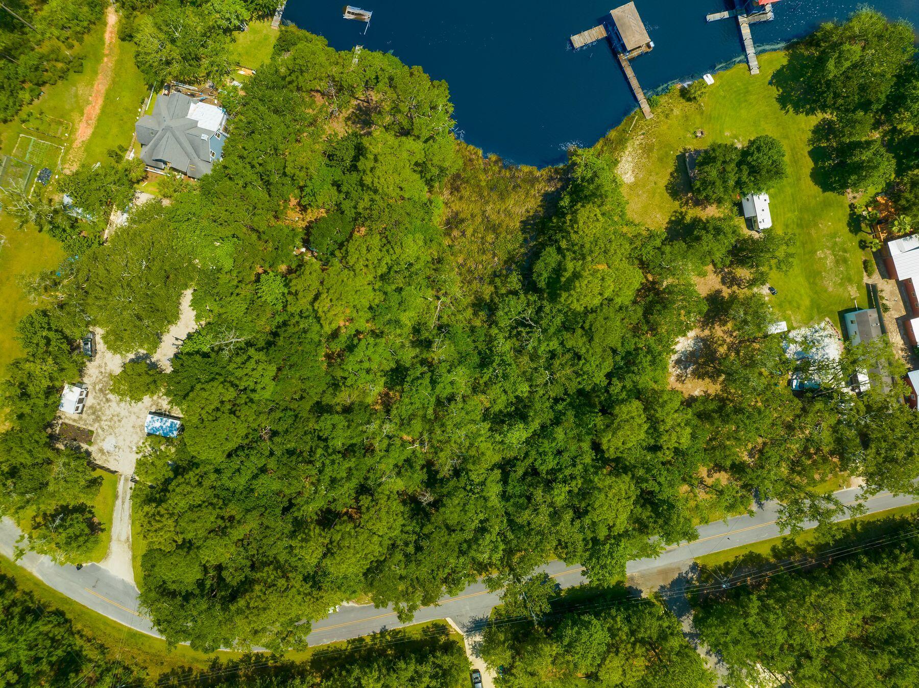 Deep open water bayfront lot with Army Corps permits in hand, this Freeport offering presents a rare, build-ready opportunity on Choctawhatchee Bay. The property includes approved permits for both a dock and required mitigation, a generous 50' x 105' buildable footprint, and no required build timeframe, allowing an owner to design, hold, or construct at their own pace. Situated on a secluded, no-HOA street, the lot delivers privacy and tranquility without sacrificing accessibility. Notably, this is the least expensive waterfront lot with permits in place under $500,000, making it one of the most compelling bayfront values currently available. Whether envisioning a legacy waterfront estate or a refined coastal retreat, this deep-water lot offers the flexibility, certainty, and timeless appeal that discerning buyers seek.