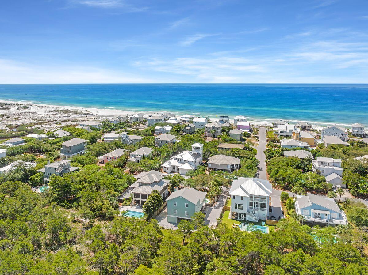 This classic beach cottage offers 2,520-sq.-ft of heated and cooled living space in the enviable neighborhood of Gulf Trace. Located between the beaches of Grayton and Blue Mountain, this community is nestled in a wooded wonderland that borders Grayton Beach State Park on three sizes and offers two neighborhood beach accesses. Featuring four beds and four-and-a-half baths, the property offers a private swimming pool, palm tree-ensconced patio, and a covered veranda for al fresco dining and outdoor cooking. Inside the home, the great room is cozy and inviting with cathedral ceilings and a fireplace. The kitchen is outfitted with stainless steel appliances and granite countertops providing both breakfast bar and dining table seating. The main living floor hosts the owner's suite with a king-sized bed and en suite bath. Additional bedrooms, one on the main level and two on the top level, offer private bathroom accommodations. Gulf Trace is a serene beachfront community positioned among sand dunes and sea oats, conveniently located near restaurants, beach bars and boutique shopping.