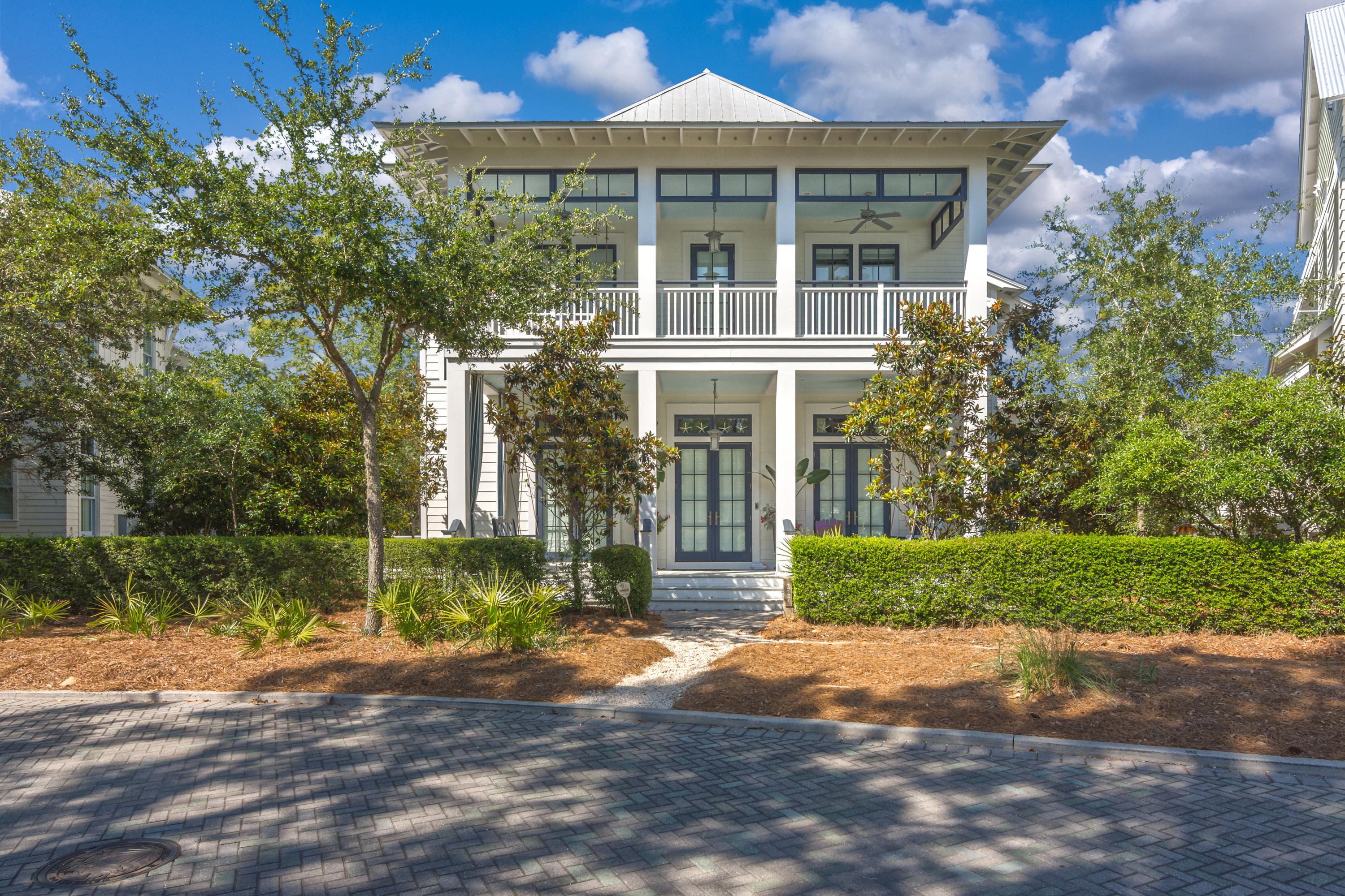 This custom beach house, carriage house and 2 car garage is located in highly desirable Watercolor Phase 3, steps away from the frog pool and a short walk to the newly expanded Beach Club and Camp Watercolor. Sold FULLY FURNISHED with a small list of exclusions. The wallpaper on the lower level and stairs will be removed and painted white. With immaculate attention to detail and special touches throughout, this home has never been rented. Exquisite oak floors, an elevator, 3 sets of french doors, custom marble floors and counters, floor to ceiling drapes with tailor-made blinds, and elegant crown molding give this home a stately and refined appeal. The well equipped kitchen features an expansive center island, a breakfast bar, a Wolf oven, cook top, warming drawer, and microwave, Subzero refrigerator, wine fridge, 2 freezer drawers, and icemaker, a Miele dishwasher, two sinks. 2 large pantries and a plethora of cabinets provide room to spare. A formal sitting room, open concept dining and cozy living room, a dedicated office space, convenient sand room with built-ins, a powder bath, and an expansive laundry room with a marble folding table, raised washer and dryer, and a built in ironing board round out the first floor of the home. The private elevator or staircase with step lighting will take you to the second floor and four bedrooms. A fifth bedroom can be found in the carriage house above the two-car garage and outdoor shower. The large outdoor entertainment space includes a refrigerator, grill, granite counter tops, and a fire pit. Custom throughout and is a must see! Call for additional information.