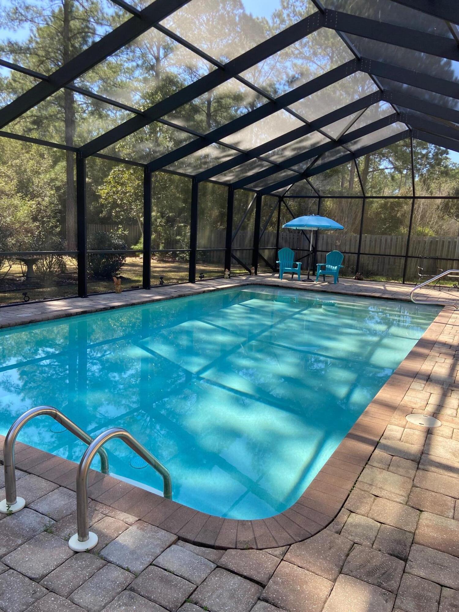 This lovely 5 bedroom, 3 bath, single story, much sought after McKenzie model home with a screened in pool awaits your visit! It is nestled in the Whispers neighborhood of Hammock Bay on a cul de sac backing to a private wooded preserve. From the freshly painted front porch to the spacious paver surrounded pool, this home is ready for you to entertain family and friends year round. Stainless appliances will contribute to your culinary successes. Granite surfaces and tile flooring in the kitchen and baths and trey ceilings and moldings add to the homes gracious ambience. The fenced backyard provides plenty of space for play and relaxation. Hammock Bay is the premier lifestyle community in northwest Florida with unparalleled amenities and features! Come see!