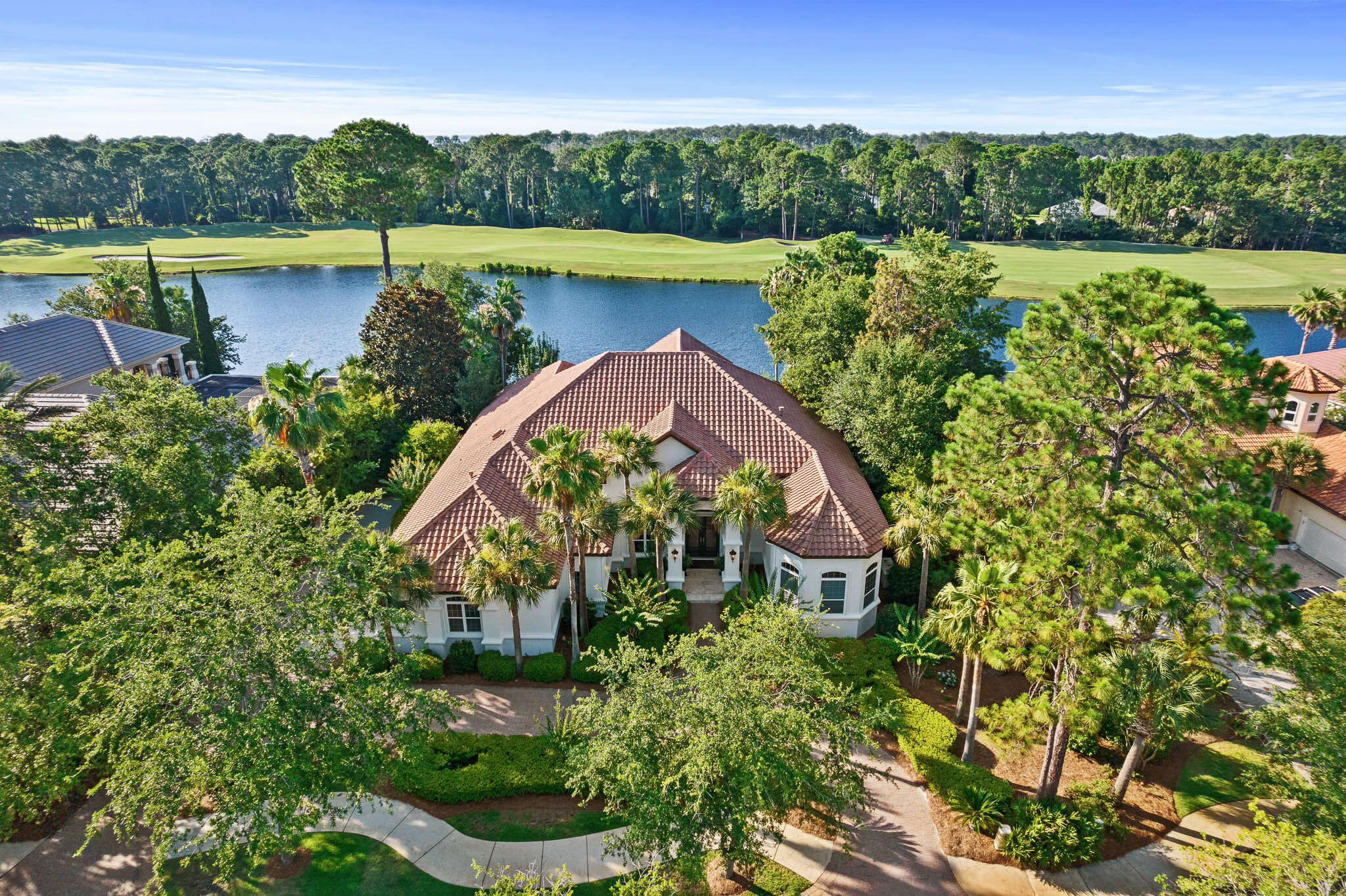 Overlooking the 5th fairway of Burnt Pine beyond the largest lake at the Rees Jones course is this custom built, fully renovated Boswell home. With an open floor plan suited for today's lifestyle, this 4,981 square foot home offers thoughtfully designed and furnished spaces that flow easily for entertaining and an oversized three car garage. The lakefront location and outdoor swimming pool provide peaceful views through floor to ceiling windows. A full renovation was completed in 2020 reflecting timeless details and finishes in each room. The main level features a formal living entrance, formal dining room, custom Wolf-Sub Zero kitchen, spacious master bedroom suite, two guest bedroom suites, laundry room, mud room, and access to the covered outdoor living area and pool with screened enclosure. The upstairs living space offers complete privacy for guests with a full living area and wet bar, screened balcony, guest bedroom suite with cathedral beamed ceiling and separate nursery. As a bonus, there is also a stylish movie room upstairs with a Bose sound system. Other features: antique heart pine wood flooring, marble and stone baths, whole house generator, built-in cabinetry throughout, custom light fixtures, tankless water heaters, custom draperies, exterior paint 2022, outdoor gas fire table., new pool filter and pump, new upstairs A/C in 2019. Furnishings included.