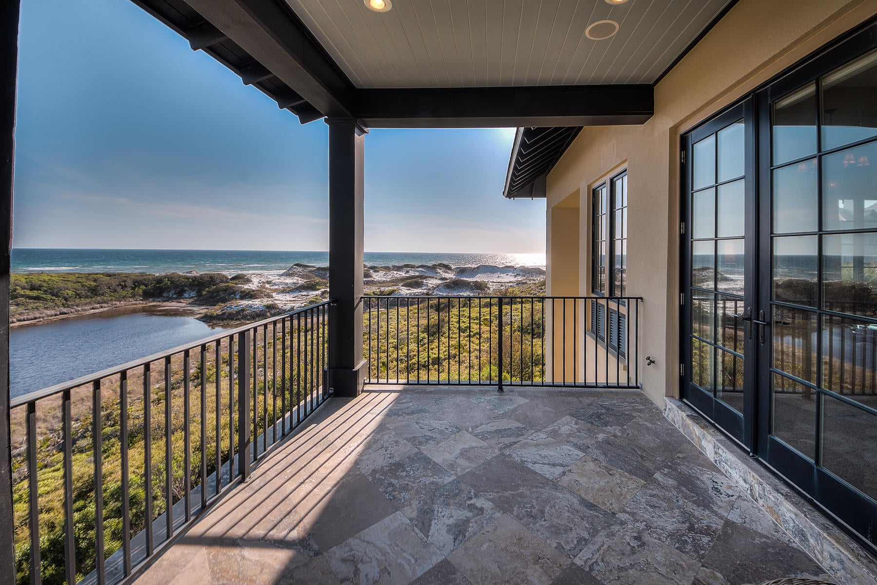 Overlooking a rare coastal dune lake with spectacular views of the Gulf of Mexico, this concrete-constructed legacy home was designed by renowned architect Dawn Thurber, Thurber Architects. Almost every room in this noble structure overlooks a layered vista of sugary dunes, sparkling lake and blue-green gulf. The generous pool deck, featuring a heated pool and hot tub, and multiple verandas offer respite for sun and shade lovers alike. The outdoor breezeway includes a wood-burning fireplace with gas logs and a Viking grill.
A wood-paneled elevator services all three levels of this traditionally appointed home. Arched doorways, paneled doors, a three-story, wrought iron stair railing and stone floors create an authentic Old World, European-style atmosphere. The open living area features dramatic ceilings and large windows framing breathtaking views. The great room showcases a large gas fireplace and conceals a TV behind artwork.

The huge, gourmet kitchen is anchored by a stunning mosaic backsplash plus a Wolf six-burner gas range with griddle, double oven, and warming drawer, Sub Zero refrigerator, ice maker and wine cooler in the butler's pantry, and Fisher & Paykel dishwasher drawers.

Six large bedrooms create plenty of room for family and guests. The ample master suite features a walk-in closet with island, sitting room, gas fireplace and large covered porch. The master bath includes a glass-enclosed shower with rainfall shower head and Jacuzzi tub. Each bedroom has its' own bath and two of the four guest suites are masters with double vanities.

Other notable features include two sets of LG Tromm front-loading washer/dryers, second and third floor wet bars, whole-house generator, two-car garage and hurricane-rated windows and doors.

About The Retreat: Located south of Scenic Highway 30A, this low-density, 90-acre neighborhood on the Gulf of Mexico is bordered by one of the area's rare coastal dune lakes. It features a gulf-front beach club with an  infinity edge pool and four neighborhood accesses leading to over 3,000 feet of private beach.
