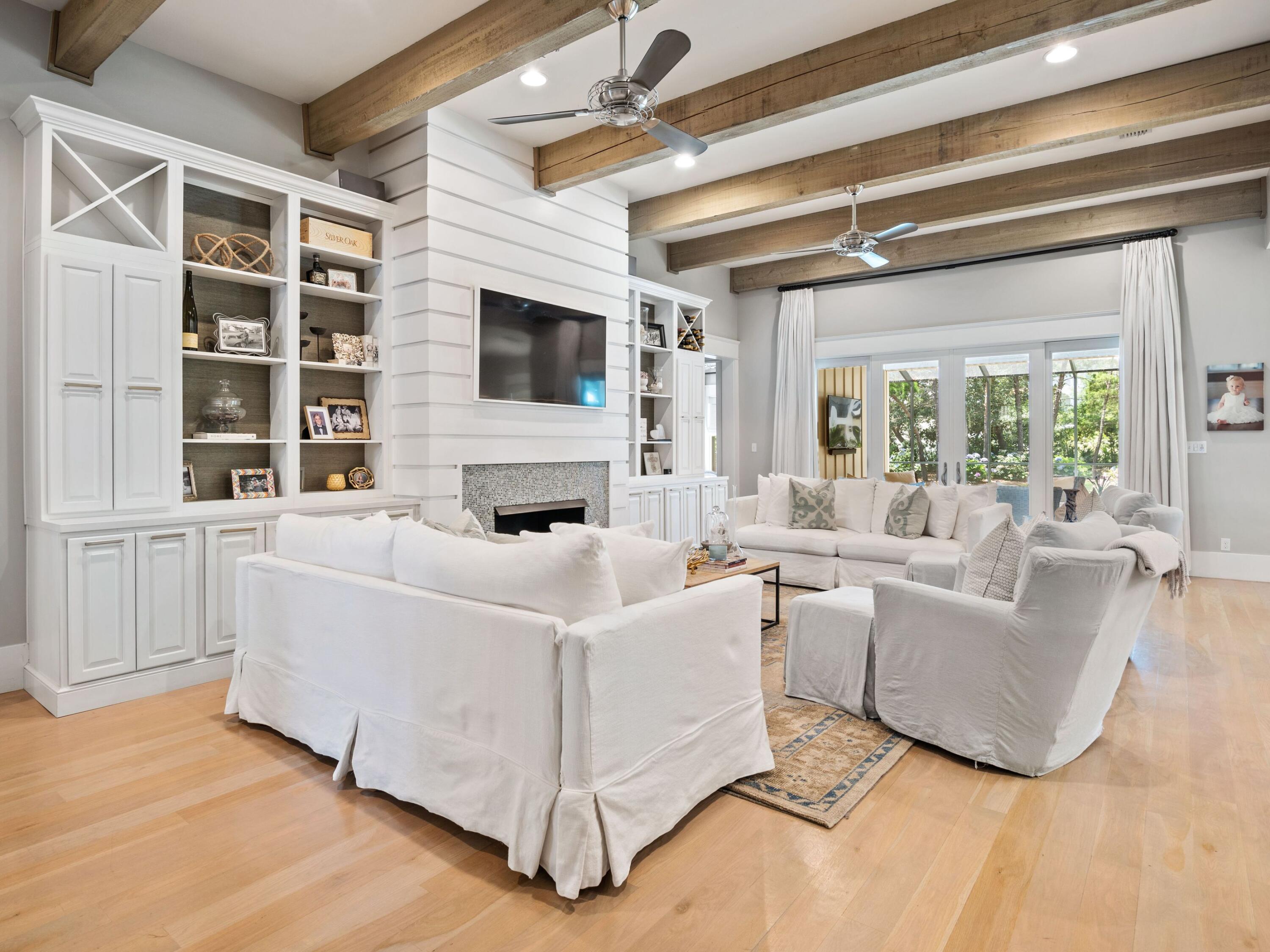 Quintessentially coastal and designed with palatial luxury around every corner, this masterfully built southern craftsman home provides an idyllic location for primary, or secondary living. Situated on an oversized corner lot and featuring four spacious bedrooms, the clean contemporary interior provides an immediate feeling of relaxation upon entry through the custom built front door. Hardwood and custom tile is showcased throughout the home, allowing light to bounce through the large portrait windows seen prominently through the property. Custom painted cabinetry and cabinet front doors adorn the appliances in the chef's kitchen, while shiplap accents and repurposed beams add additional touches of luxury desired by today's sophisticated home buyers. A masterfully designed outdoor oasis offers screened - in serenity fully outfitted with an oversized sitting area, private pool, fireplace and alfresco dining. Charleston brick and cedar accents flow in unison with the crisp cream board-and-batten exterior, crafting an equally timeless and elegant design to this showcase property. Imported designer lighting and a rare three-car garage offer additional touches and class and convenience to the more than 2,900 square feet of living space, all within three blocks of the crystalline waters of the Gulf of Mexico. The prime Seagrove Beach location also enables quick and easy access to top area shops and restaurants as well as both Seaside, Florida and WaterColor town centers and amenities.
