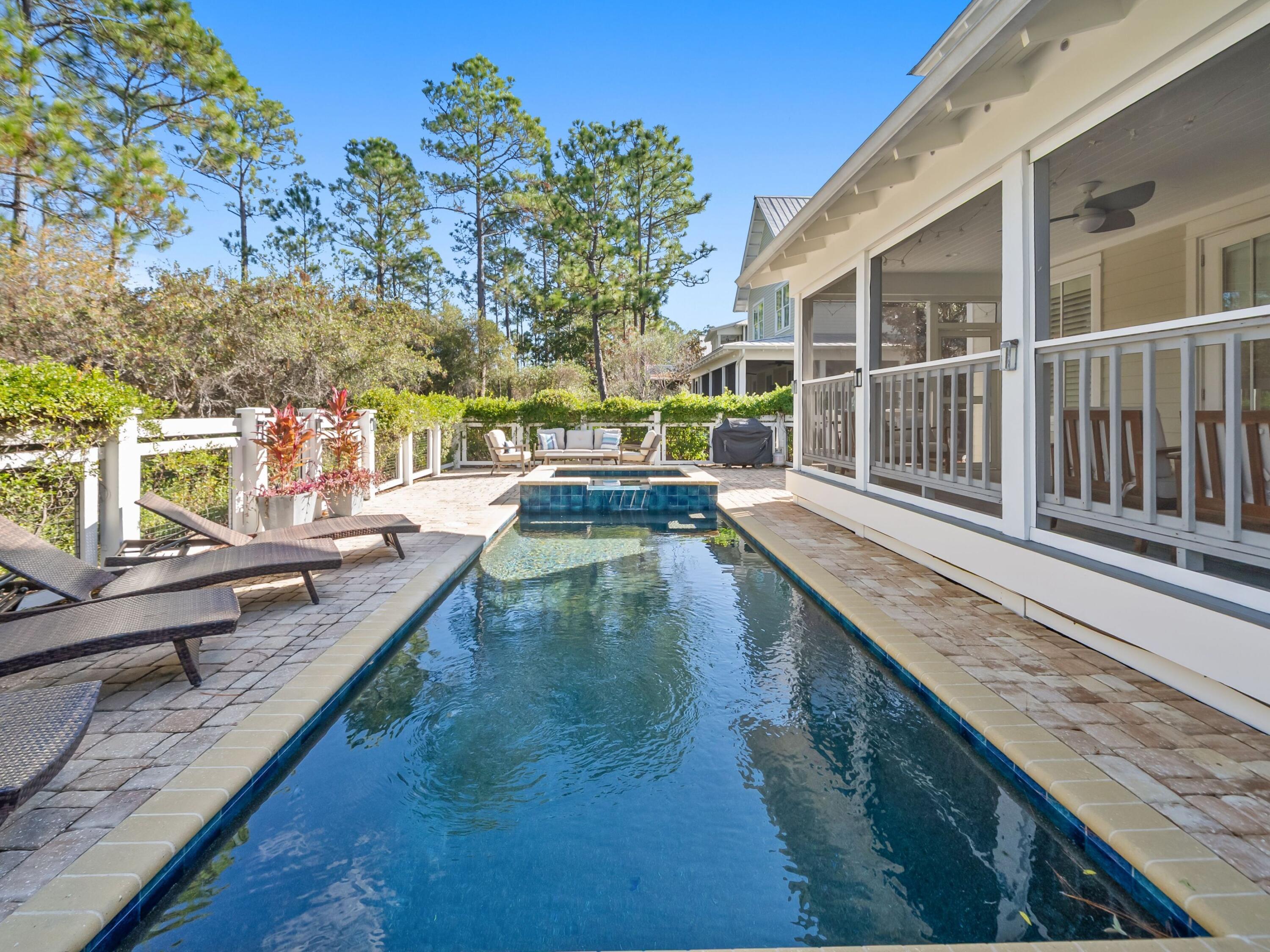 With its rare combination of privacy, upgrades, and enduring style, this extraordinary retreat stands among WaterColor's most compelling offerings. 71 Sunflower St. is the lowest-priced home in WaterColor with a private pool, set on a homesite that backs to preserved land that will never be built upon. This captivating home has been cherished as a non-rental second residence and is beautifully furnished with only a few exclusions of artwork. Thoughtful upgrades include designer lighting, new Quartz countertops, refinished hardwood floors, new bed linens, designer-grade furnishings, and fully updated saltwater pool equipment totaling $20,000. Sunlight drifts through the home's abundant windows and French doors, settling into the open living spaces where imaginative lighting casts a soft glow over conversations that stretch from the Carrara Gold-topped kitchen to the deep porches overlooking the forest. Built by Romair Homes with a host of enhancements, the home feels both refined and deeply comforting, a place where laughter around the island becomes its own kind of ritual.

The first-floor primary suite opens directly to a calming porch overlooking the expansive private pool, inviting slow mornings with a cup of coffee and the rustle of birds in the trees. Upstairs, an additional primary suite joins two guest rooms with private baths and a cozy bunk den for sleepover guests. French doors lead to the upper porch, where a swing bench captures the breeze and adds a nostalgic sense of calm.

Outdoors, the private saltwater pool and whirlpool spa feel beautifully sheltered, framed by mature greenery and permanent open space. Indoors, Wolf and Sub-Zero appliances, a wine refrigerator, a wet bar, and generous porches make entertaining effortless. Recent improvements include two new HVAC systems, new washer and dryer, and an array of new furnishings that give this stunning residence a fresh, welcoming, and effortlessly luxurious feel.

Joyful neighborhood exploration awaits, from Camp WaterColor's pools and lazy river to Western Lake's boathouse and the gulf-front Beach Club. Woven through the community are parks, sports courts, trails, and boardwalks that lead to unforgettable days in 30A's most coveted community. An inviting flow, elegant design selections, numerous upgrades, and with a golf cart conveying with sale, this appealing residence is a true turnkey experience for those looking to make extraordinary WaterColor memories of their very own.