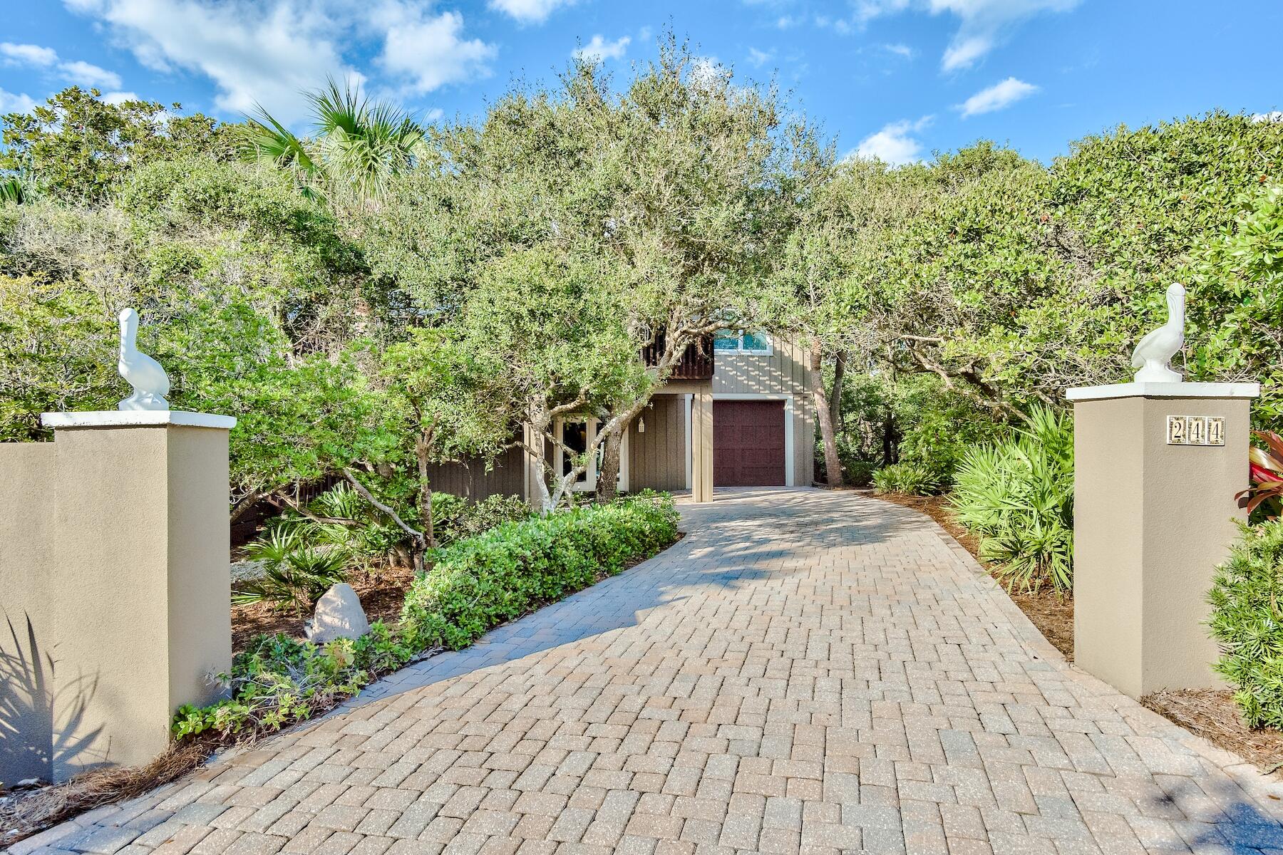 This is a very special property in a fantastic location! Enjoy spectacular gulf views in a quiet, secluded setting! This 2 bedroom, 2 ½ bath home is situated just 100 yards from the Stallworth beach access and is nestled among mature oaks and magnolias. The house offers wraparound porches and a large observation deck all constructed in Ipe Brazilian hardwood. Completely remodeled in 2008, the main level has a large master bedroom with ensuite bath and large walk in closet featuring custom built in cabinetry. The great room/kitchen area has stainless appliances and granite countertops. There is a half bath, separate dining room and a spacious light filled sitting room with custom cabinetry and wine fridge. Downstairs provides a large entryway with built in cabinets, laundry room and a second master suite with fireplace, bathroom and huge walk in closet with custom cabinetry. There are hardwood floors throughout, refinished in 2021. All interiors repainted in 2021.The deck surrounding the first floor has an outdoor shower and storage area. The rear of this property provides ample space for sitting/entertaining areas in the cool shade of mature oaks and magnolias. Large 75' x 150 Lot with ample space to add a pool and or carriage house. This is a very special property in a fantastic location!