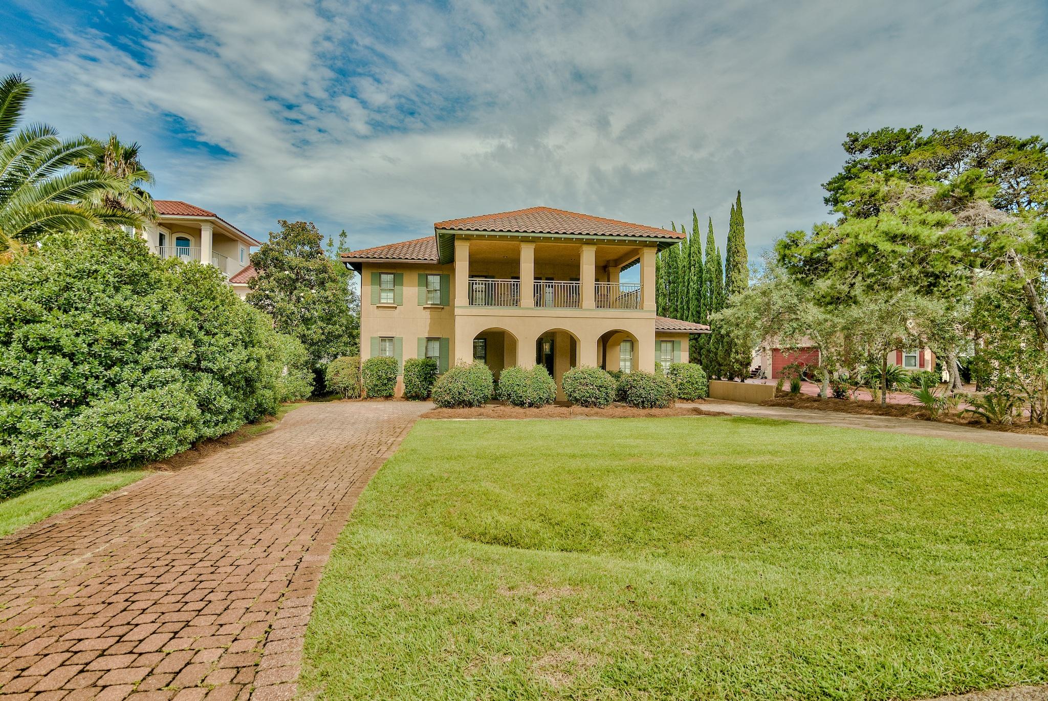 Quality and architectural design throughout this custom built home distinguish it from other properties. This four bedroom home features the master bedroom and bath on the first floor with three additional bedrooms, a bonus room, and an office upstairs. Custom features include custom hand hewn river recovered pine staircase and multi width pine floors mixed with brick pavers, old vintage beams throughout great room and foyer, solid limestone fireplace, impact resistant double hung windows and doors, Baldwin hardware, and a custom made solid mahogany front door. The kitchen features custom cabinets that are raised with rollout drawers and granite countertops. Open floor plan offers a sitting area in the kitchen which is wonderful for entertaining. Kitchen Aid pro series stainless steel appliances, gas cook top, double ovens, and a built in 48 inch refrigerator.The second floor features 3 bedrooms and 2 full baths plus a bonus room and office.  The landing leads to an amazing second floor porch!
Outdoor living on the first floor back porch, a large backyard, and an oversized garage are just a few of the many features of this home. Walking distance to the beach and a private neighborhood beach walkover for Bella Mar residents. Hop on a golf cart or walk over to the great shops and restaurants near by. Bella Mar has private trails throughout the gated neighborhood to enjoy walking and biking and golf carting.