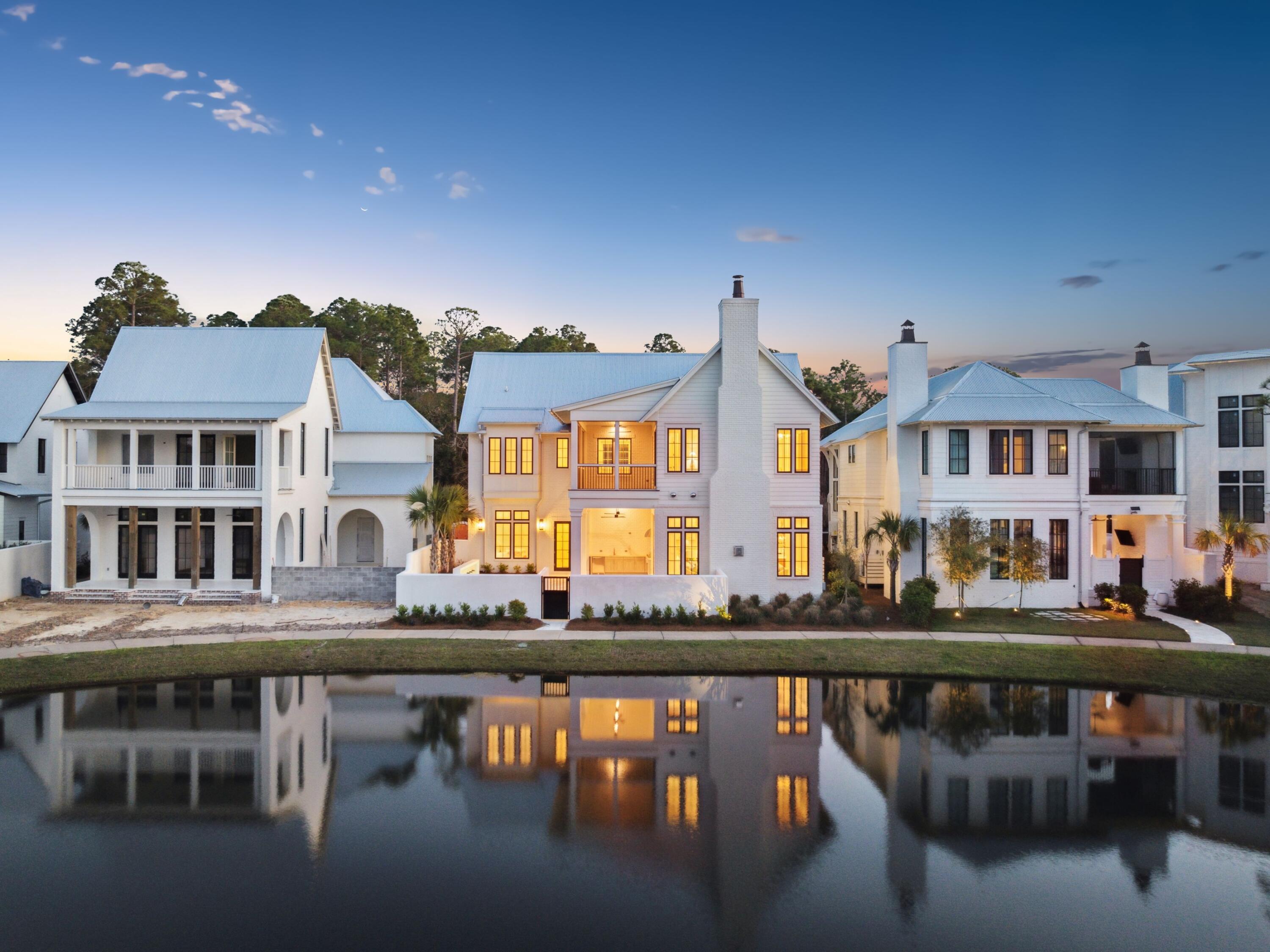 Tucked away in the coveted bayfront community of Churchill Oaks, 267 Tyler Drive is a newly built lakefront estate that blends coastal sophistication with relaxed luxury. Offering five bedrooms, dual primary suites, and a private carriage house, the home is designed to elevate everyday living while embracing the beauty of its lakefront setting. A timeless exterior of painted white brick, lap siding, and wood accents sets the tone, while lush landscaping frames the inviting front porch and entry. Inside, white oak plank floors, soaring ceilings, and expansive windows create light-filled interiors with effortless flow. The open-concept living area is anchored by a Venetian plaster fireplace and opens seamlessly to a lakefront courtyard with pool and cascading water features. The chef's kitchen impresses with Taj Mahal quartzite countertops, custom cabinetry, a waterfall island, and an integrated bar with wine cooler, while the primary suite on the main level offers a spa-inspired bath with marble finishes, soaking tub, and expansive custom closet. A second primary suite upstairs and en suite guest rooms provide luxury at every turn, with a private elevator ensuring easy access to all levels.

The carriage house above the detached two-car garage serves as an ideal guest retreat, complete with living space, bedroom, bath, and private balcony. Beyond the home, Churchill Oaks offers resort-style amenities including a deep-water marina with 36 slips, bayfront clubhouse, fitness center, and pools overlooking Hogtown Bayou. A boat slip is also available to purchase with the home.

As an added incentive, the seller is offering a $25,000 buyer credit toward closing costs and furnishingsmaking this lakeside sanctuary an even more compelling opportunity in one of 30A's most desirable waterfront enclaves.