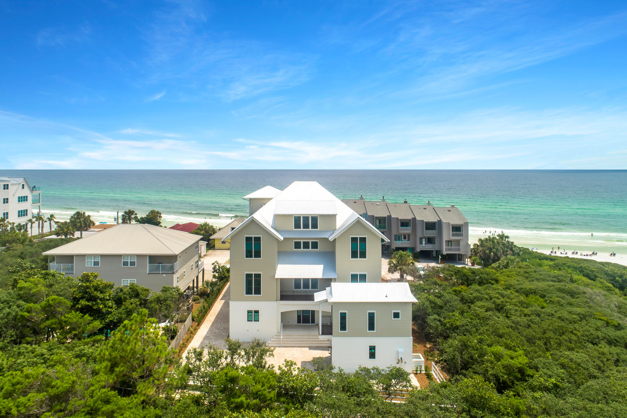 Sweeping forever views of the Gulf of Mexico paired with astonishing architecture characterize this exquisite Seagrove Beach estate. Positioned adjacent to the sugar white sands, 40 Hinton-Bishop Drive offers private beach access within steps of the front door, a large resort style private pool, a detached carriage house and views from every level. The well-thought-through floor plan offers over 7000 square feet, 10 bedrooms, 10 full bathrooms, 3 half bathrooms and over 4000 square feet of porches. Features of the home include reclaimed beams in the great room, reclaimed oak flooring throughout the upper levels, coral shell stone floors on the ground floor, pine wood walls throughout the home, brick accents, a gas fireplace, a 4 stop elevator, garage, designer finishes and luxury fixtures. The 4th level roof top terrace is truly breath-taking. Featuring two separate entertaining areas, an outdoor wet-bar and an additional restroom; the sky veranda is the perfect place to host your guests while enjoying 180 degree views of the emerald waters and show-stopping sunsets.  The great room is highlighted by the large chef's kitchen showcasing a 48" gas Wolf range, 36" Sub-zero refrigeration, 36" Sub-Zero freezer, dual dishwashers, under counter ice maker, under counter beverage center, double islands, quartzite countertops and custom cabinetry. An extremely spacious living room and additional sitting area are also located within the great room. The ground level of the property boasts a large recreational room for billiards and lounging. Additional living spaces are found throughout every floor of the property. The unparalleled outdoor living areas feature a resort style pool, 2 outdoor summer kitchens and numerous locations for enjoying the breeze of the Gulf of Mexico. 

*Finished photos of property are of the same floor plan built in another location.