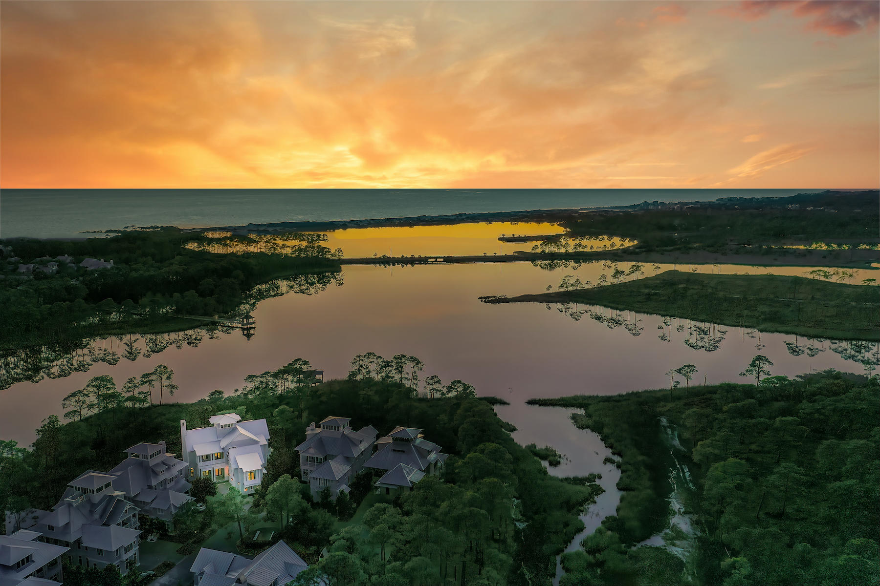 Step through the front doors of this private WaterColor retreat and you'll know you're home. 

Nestled on a quiet cul-de-sac backing up to forever green space and glittering views of Western Lake beyond, this 2018 build by Chris Clark is ideal for a buyer looking for all the amenities and activities available in WaterColor with a quiet reprieve from the hustle and bustle of a resort community.

Featuring six bedrooms, two bunk-rooms and a full home gym, this Vermilion Way home boasts the absolute best location to live in and enjoy all that WaterColor has to offer. Flawlessly designed by Geoff Chick & Associates in collaboration with Robyn Prince and Marianne Temple, the entire home is filled with sensational architectural details, remarkable craftsmanship and a bright and airy coastal ambiance that will leave you speechless.

The first floor is designed for entertaining and warm fellowship with open-concept living, dining and kitchen spaces. Step outside onto the deck where a 75-ft. lap pool with heated spa and firepit await. Beyond the kitchen, outfitted with Wolf appliances, you'll discover a butler's kitchen and glass wine cellar with wet bar. A mudroom flows out to a 2 ½-car garage that sits beneath an exquisite carriage house, complete with a full kitchen, private bedroom and bunk room. 

Take the elevator to the second floor where you'll be ensconced in cozy serenity with two pronounced master suites featuring luxurious baths and ample his-and-hers closets. Each suite opens onto a deck with hanging swing beds and lake views. A bunk room includes sleeping quarters for two and room for a home office or reading nook, and an oversized laundry room with dual washers and dryers is conveniently located for all.

The third floor provides a second living area with wet bar, two additional bedrooms and two full baths. The pièce de résistance, however, awaits in the home's fourth-floor tower featuring stunning lake and gulf views. 

The home's comfortable and inviting furnishings have been expertly chosen and styled to perfection, making this beach house the perfect Florida retreat  situated on the highest elevation in WaterColor.