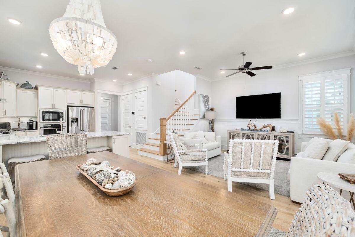 Located south of 30A, this beautiful 2019 beach house is offered furnished and comes with several outdoor porches and many extras. Check out the plantation shutters, tankless water heater and crown molding along with the cool coastal décor. Step onto the front porch where a swing loveseat invites you to linger. It's the perfect outdoor space for lazing and reading in the shade. This contemporary home has a popular floor plan including a master suite with generous closet, ensuite master bath, guest bathroom and laundry all on the first floor. Hardwood flooring, shiplap and wooden stair treads add a touch of nature to the bright living area which has well-defined areas for dining, entertaining and relaxing in front of the 65-in. smart TV. Another generous porch for alfresco dining and relaxing. The kitchen is a spacious hub inspiring creativity with maple cabinetry, stainless appliances, gleaming quartz countertops and a pantry. Keen cooks and pasta lovers will appreciate the pot filler faucet above the stove delivering instant hot water straight to the saucepan. A breakfast bar and a row of stools provide a natural gathering place for informal dining, cocktails and socializing. The clean lines and light contemporary ambiance continue upstairs in two additional bathrooms and three guest bedrooms which include a bunk room and second master suite. Views from the deep second-floor balcony overlook the stunning community pool just across the street. A paved driveway and one-car garage round out the amenities, providing additional storage space for beach toys and bicycles. The exclusive Prominence community on 30A includes a fitness center, plenty of green space, resort-style pools, gazebos and bike paths to the Town Center. This turnkey home would be suitable as a full-time residence, second home or investment property. Conveniently close to beach access, shopping, dining and entertainment at The Big Chill (formerly The Hub), it's well-located for visitors and rental guests.