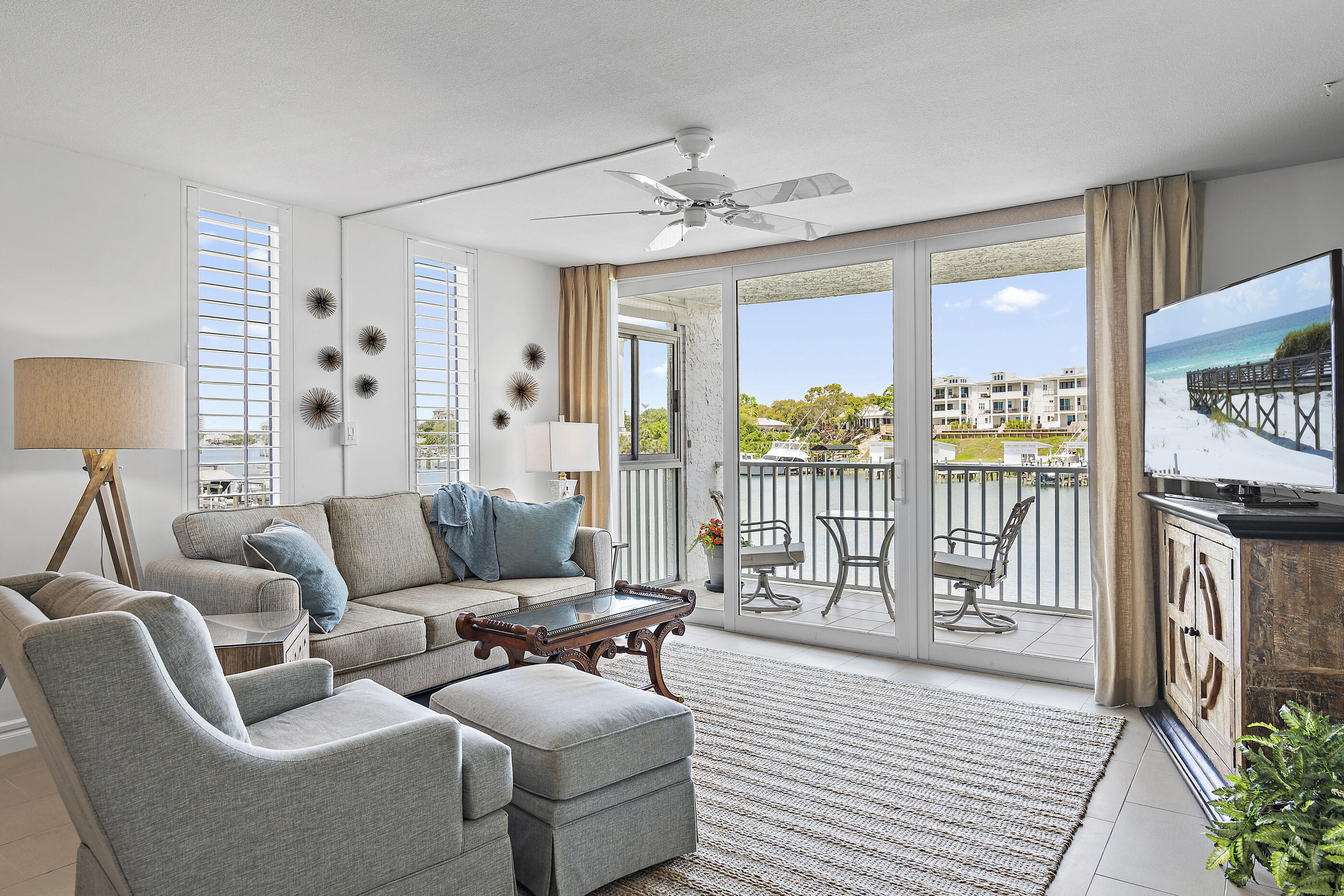 Enjoy spectacular views of the harbor in this beautifully renovated two bedroom Dolphin Point condo. The unit has grey tile floors in the kitchen/living area, new appliances, granite countertops, penny tile backsplash, all new lights fixtures, washer and dryer, and extra windows to enhance the views of the harbor and Destin bridge. A large exterior storage unit provide space for all your beach toys or extra household items. Dolphin Point has amenities galore including a private pool, clubhouse, tennis/pickleball courts, dock, kayak and paddle board storage, grilling areas, and access to the beach is literally just down the street. In addition, you're a member of Holiday Isle and have access to their gated beach accesses.