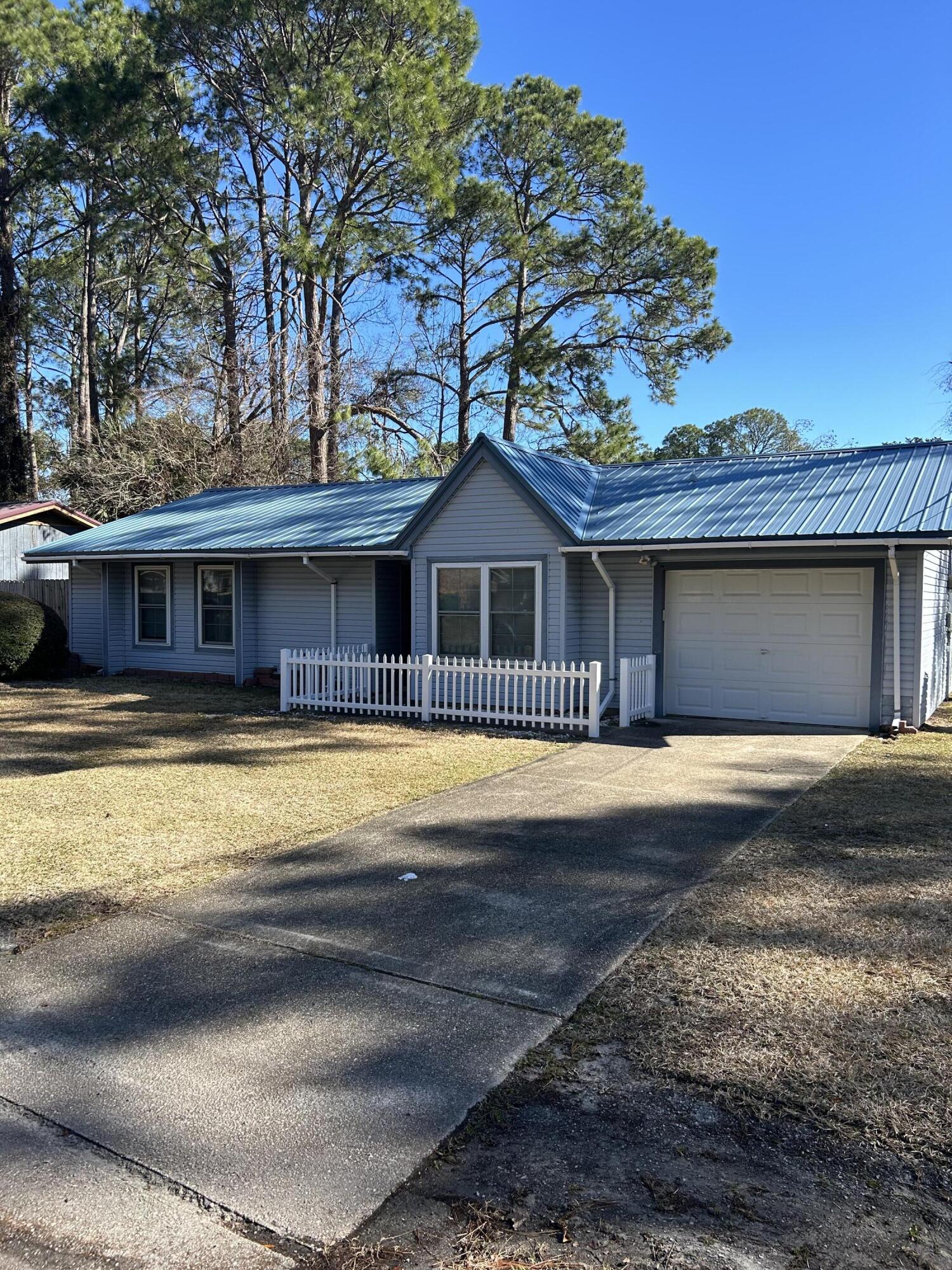 Centrally located near Eglin and Hurlburt, Schools, and shopping, with a nearby golf course, this home features a large fenced yard, sizeable shed/shop, and an attached garage. Designed for ease and comfort all bedrooms are situated on one end, offering privacy and a quiet retreat. Ideal for military families and outdoor enthusiasts alike.