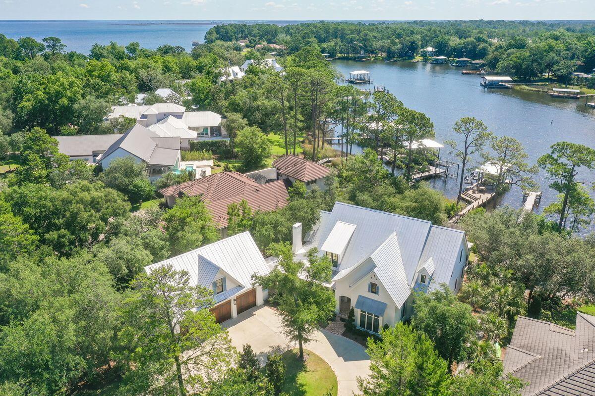 This amazing home in the gated community of Botany Bayou has everything you'll need for a full-time residence or vacation home on the bayou! This custom home has 75 feet of bayou frontage with a custom, covered dock that includes a boat lift with boat and two jet ski lifts with jet skis. The first floor has a master suite, a guest bedoom, living room and separate living area with attached screened porch and outdoor fireplace. The family room, dining area and kitchen are open and perfect for entertaining or family get togethers. The kitchen has Sub-zero and Wolf appliances as does the Butler's Pantry.  The master suite on the back of the home has views of the bayou through a screened porch and hot tub. There are two walk-in closets, marble shower and soaking tub. The back of the home has an outdoor kitchen and is covered from the elements. There is a separate storage room off the back of home with a full-size refrigerator and ice machine and enough storage for paddle boards and more. The second floor has two living rooms and sitting areas and three more bedrooms - one that can easily be an office. Enjoy the convenience of your very own private elevator as well. There is a separate carriage house complete with three-car garage and another bedroom, full bathroom and living area upstairs. This home has all the finishes you'd want: shiplap walls and ceiling, custom tile showers and bathrooms, granite and marble counter tops, top-of-the-line appliances, ornate door hardware and much more! This is the complete package sold fully furnished including a 2021 boat, 2 jetskis purchased in 2020, a golf cart, and fitness equipment.
All room dimensions and square footage are approximate and should be verified by the buyer.